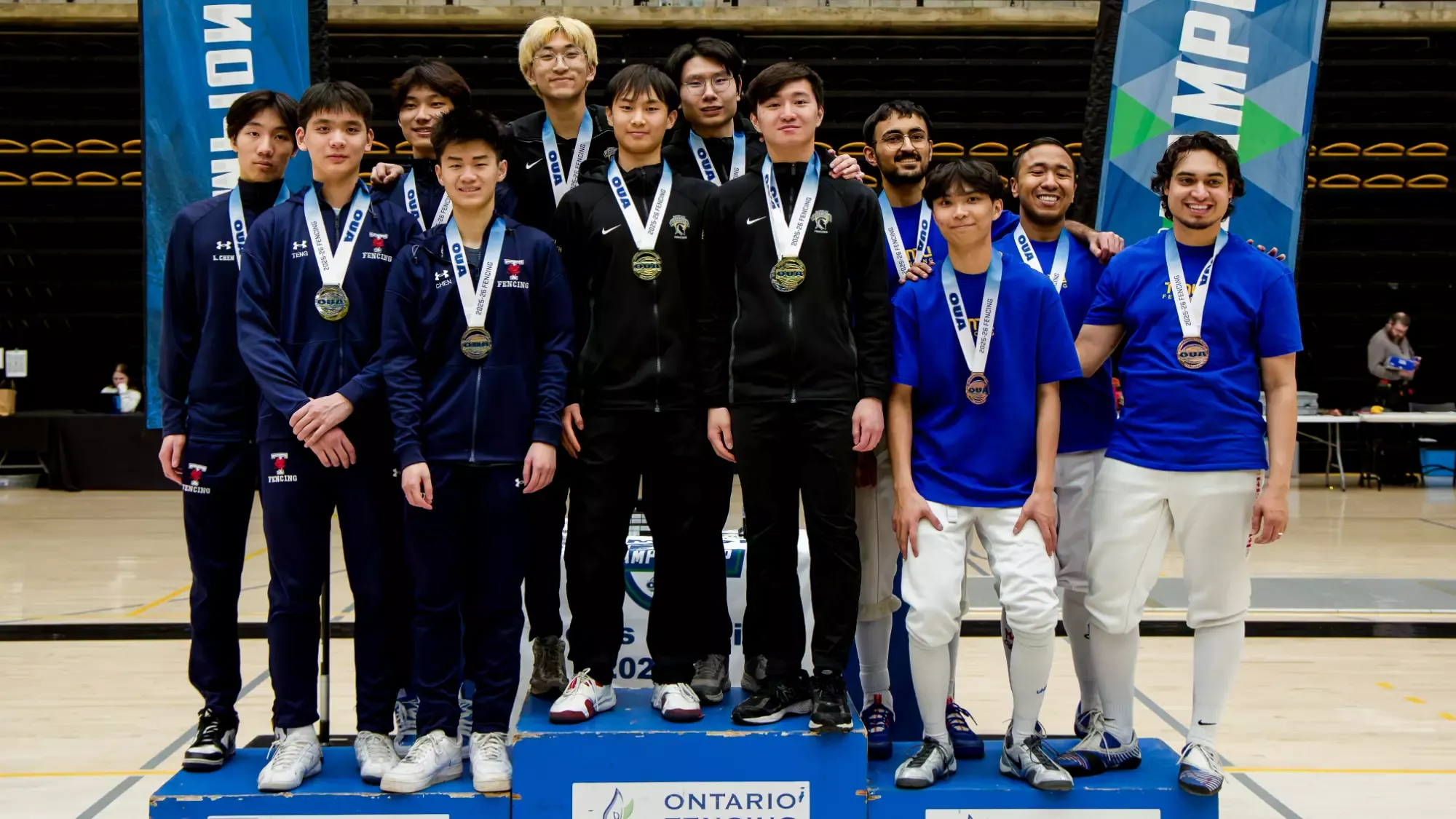 The TMU fencing team is recognized on the podium at the OUA Championship