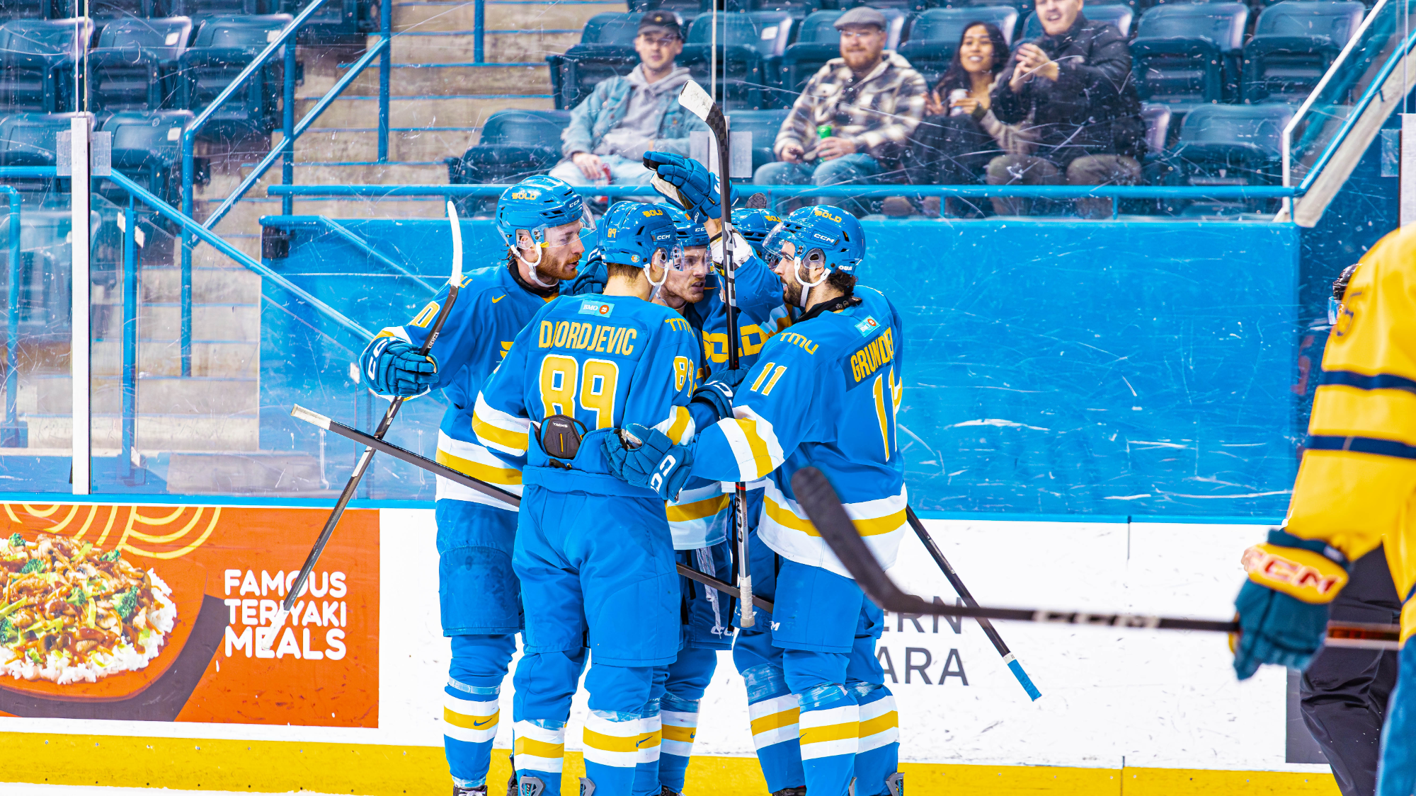 Bold players huddle together versus Queen's