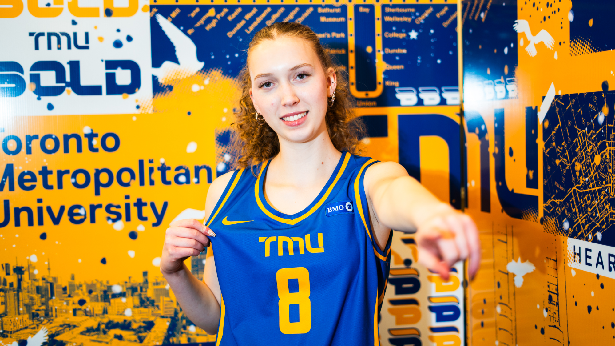 Sophie Nicholson poses in a TMU jersey
