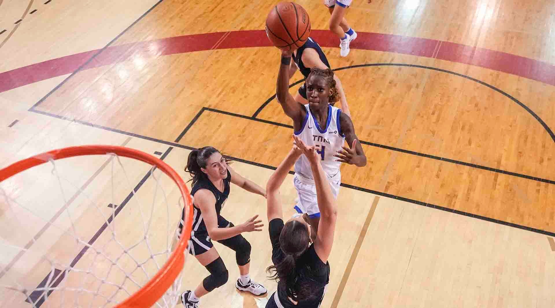 Myriam Kone takes a shot over a UBC defender in the consolation semifinal