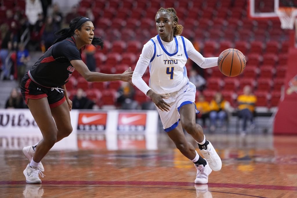 Bold Guard Myriam Kone Attacks a Ravens Defender