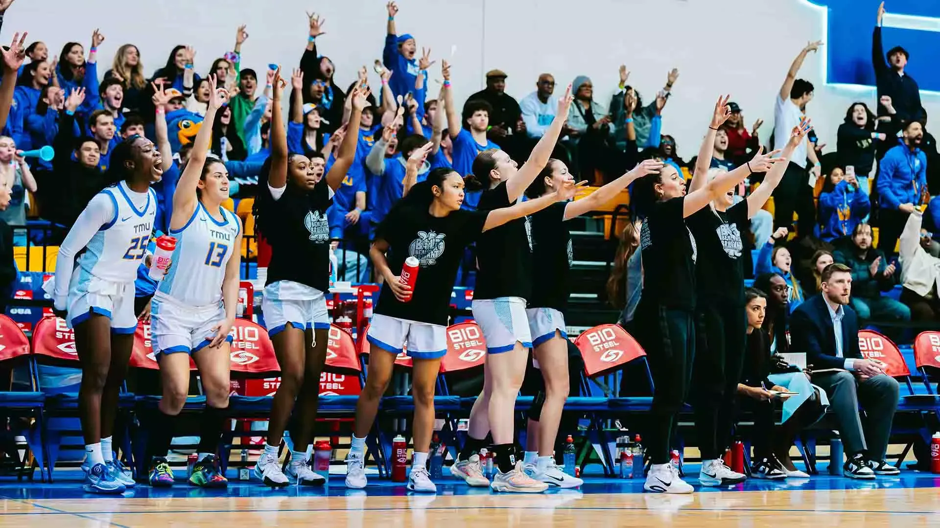 The Bold bench celebrates a basket against the Carleton Ravens