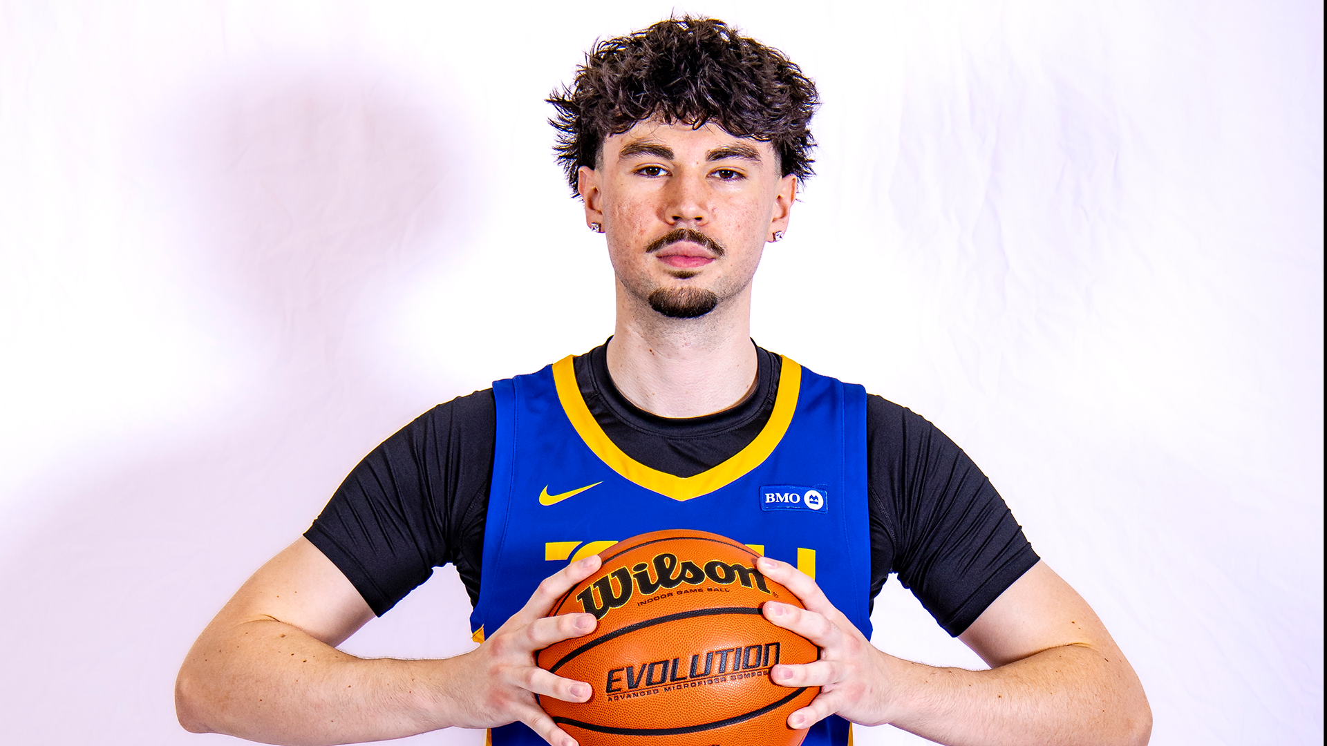 Olivier Desjardins poses for photo after commiting to the Toronto Metropolitan University Men's Basketball program.