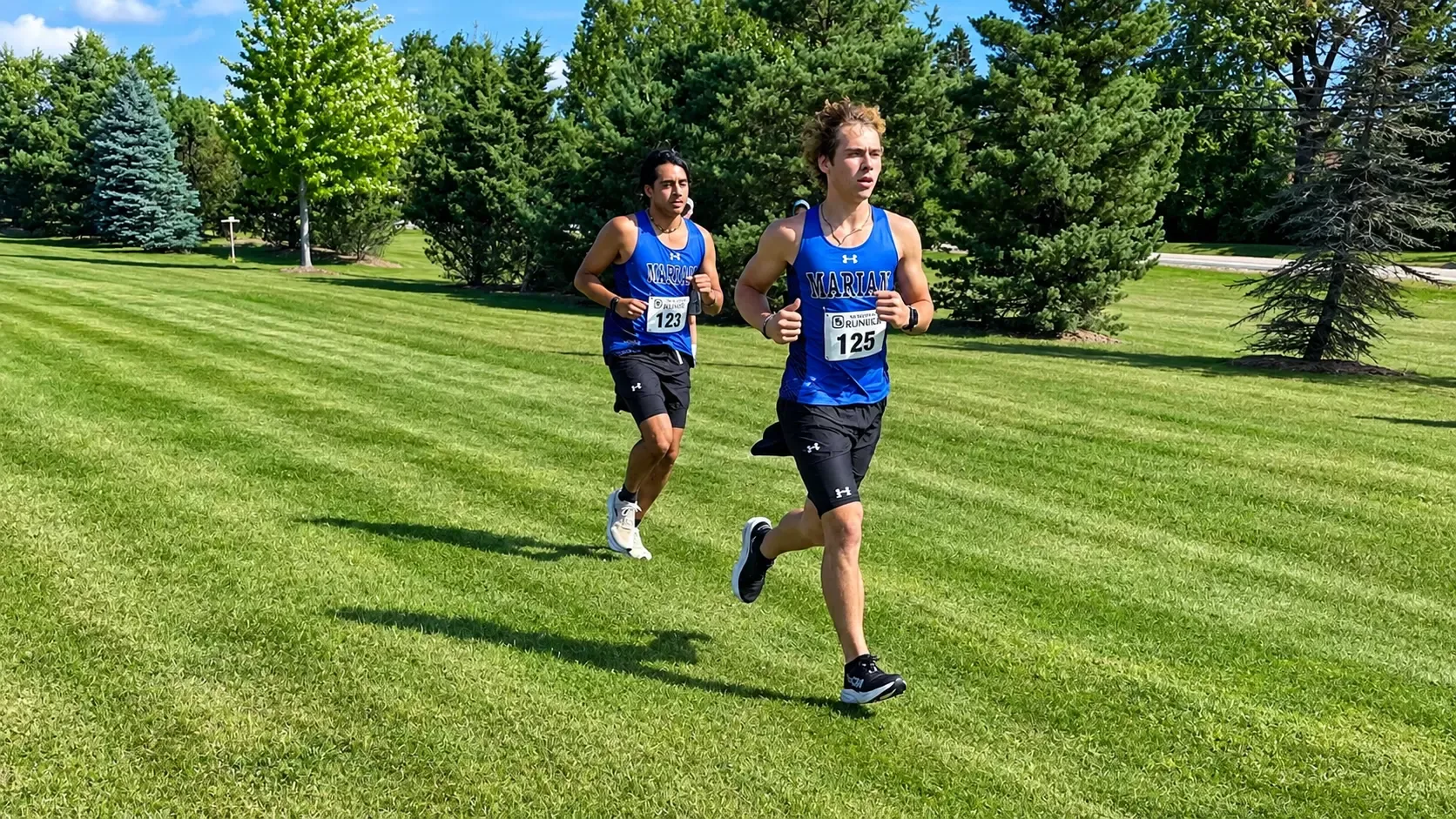 Baden Ramirez and Greg Spaeth run in a meet