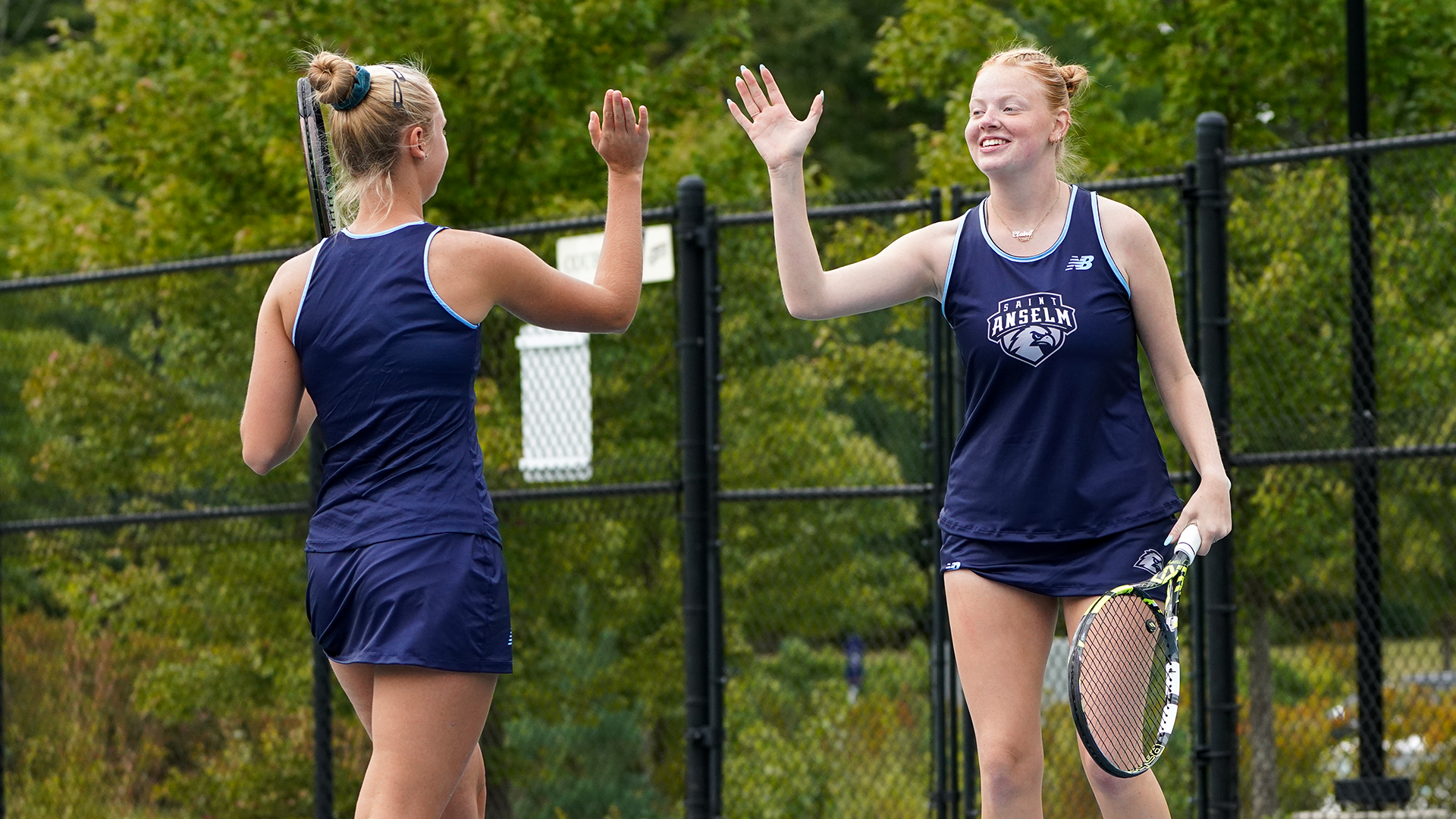 Makarenko and Kochenbach celebrate during doubles play