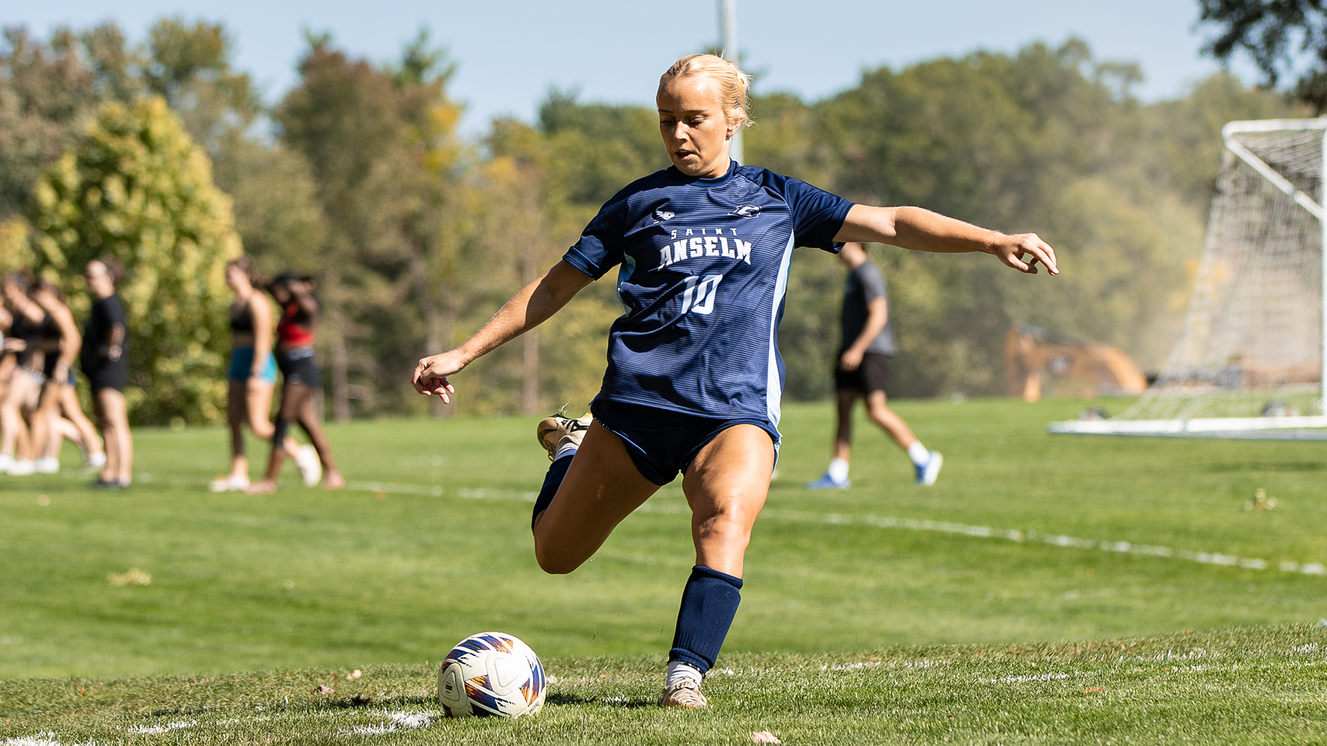 Daniella Atherton kicks the ball in on a corner kick.