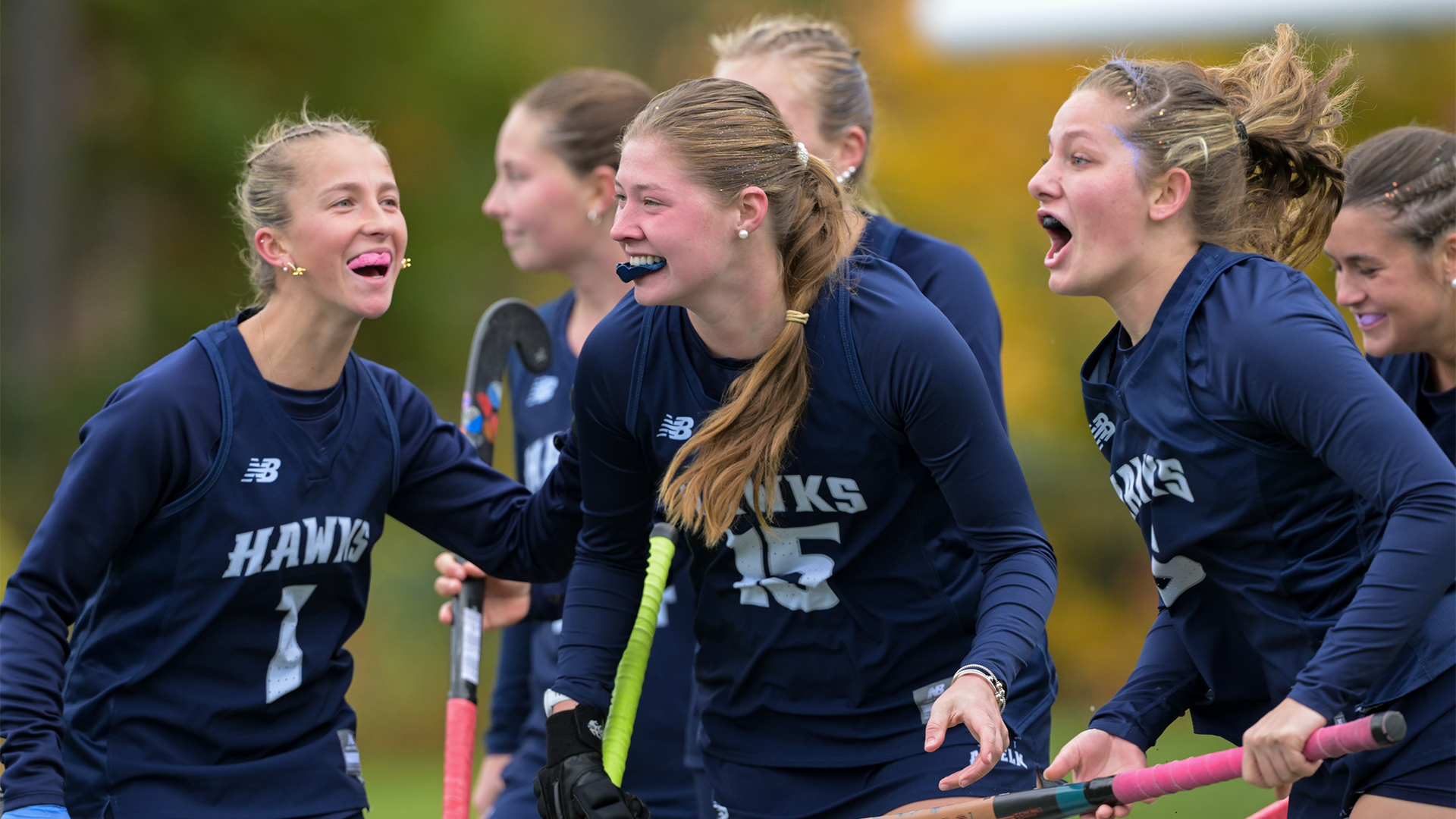 Field hockey players celebrate goal