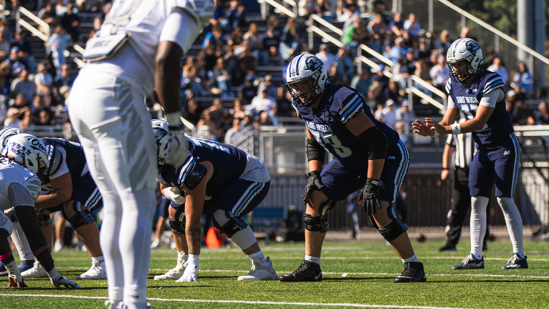 Saint Anselm football players await snap for next offensive play