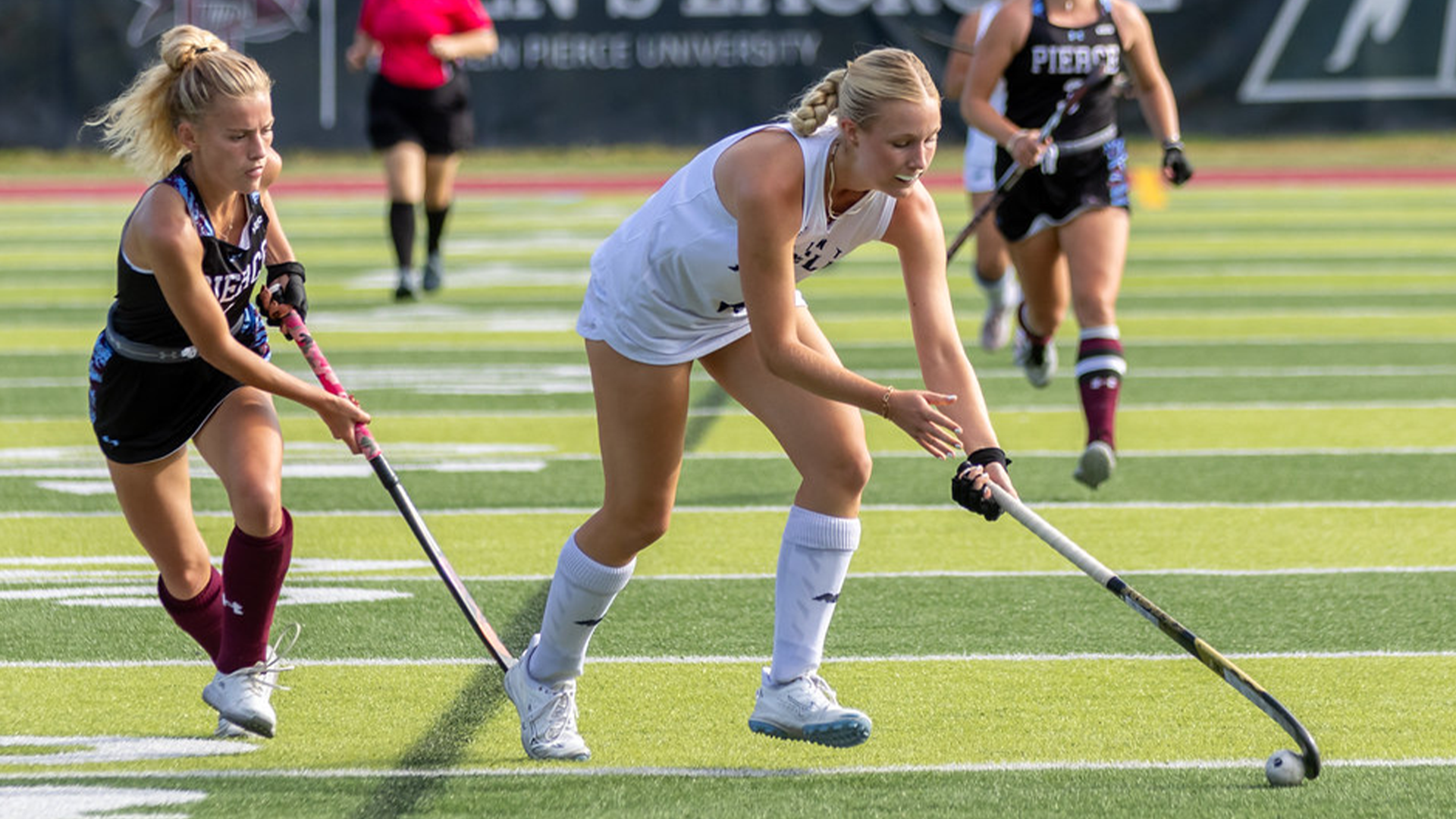 Leila Härtel runs down field with ball on stick