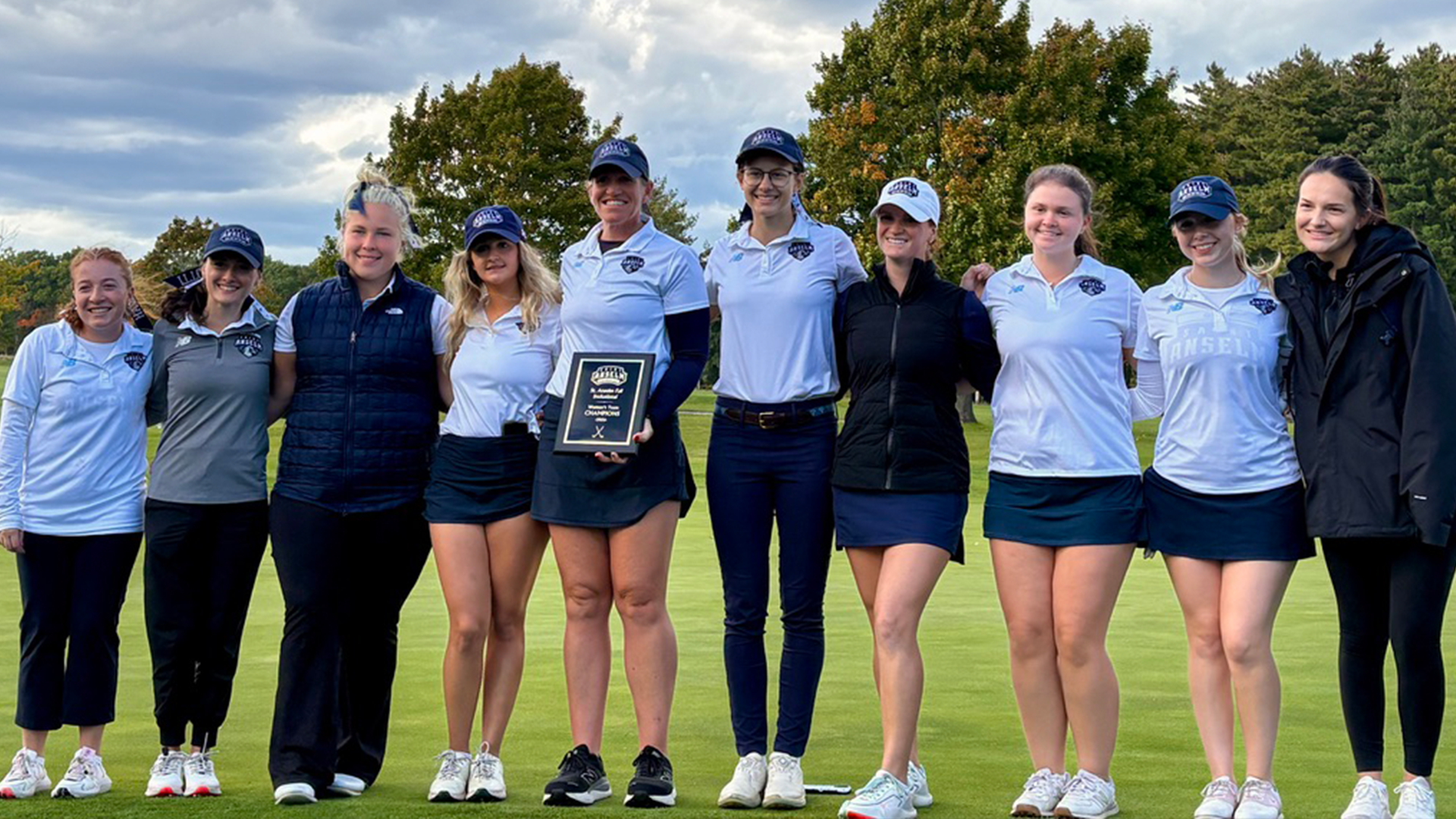 Women's golf team with the trophy after winning their tournament. 