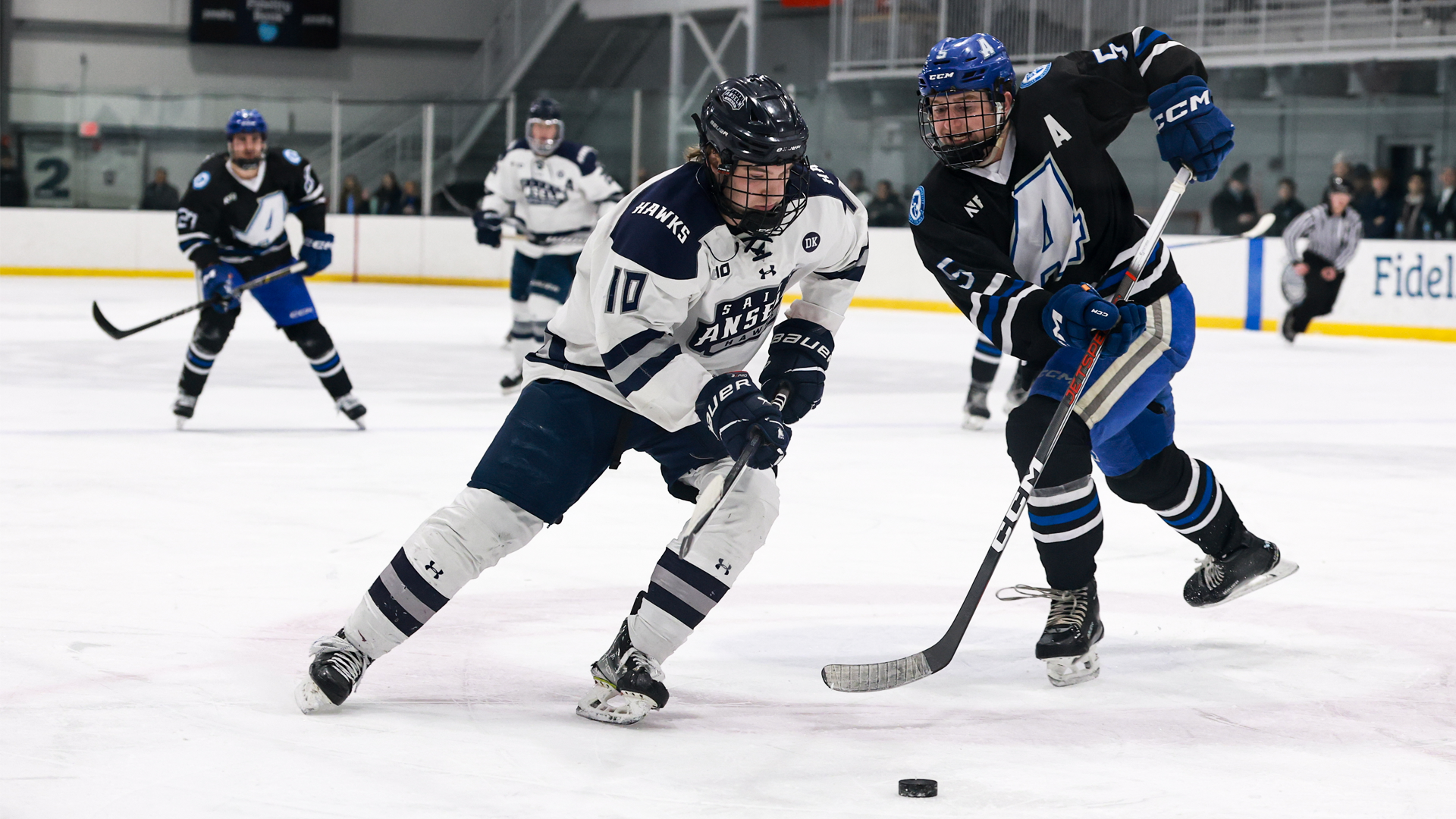 Cam Collins skates with puck in offensive zone