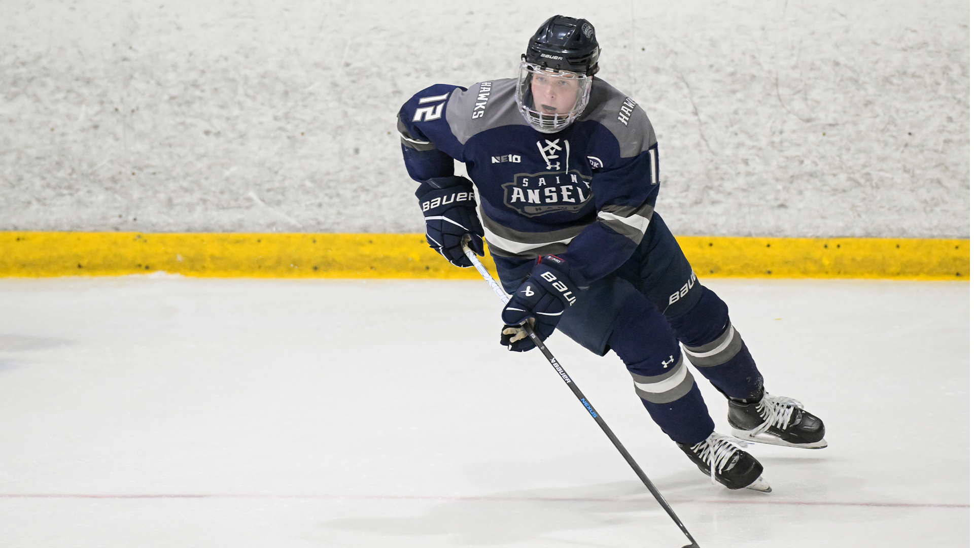 Alec O'Connor skates with puck
