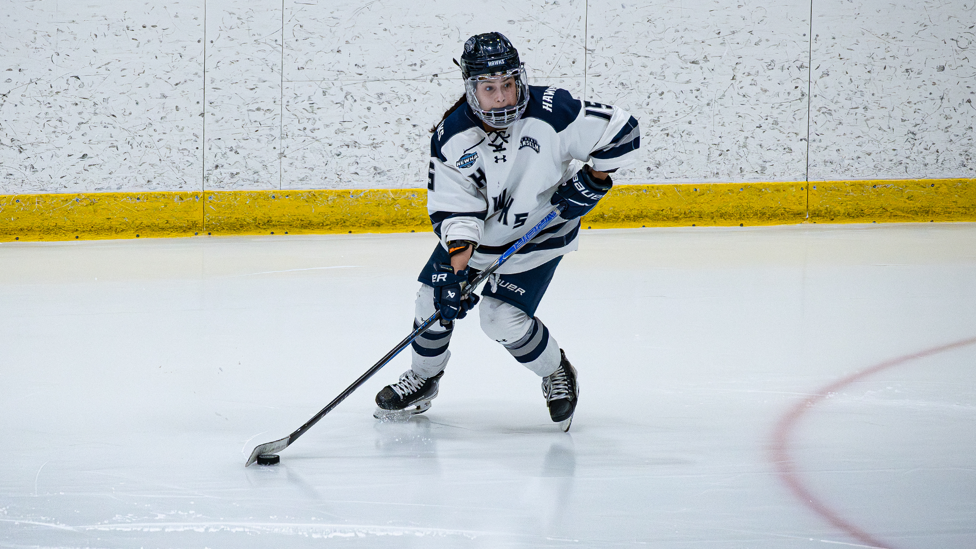 Kismet Dogan skates with puck