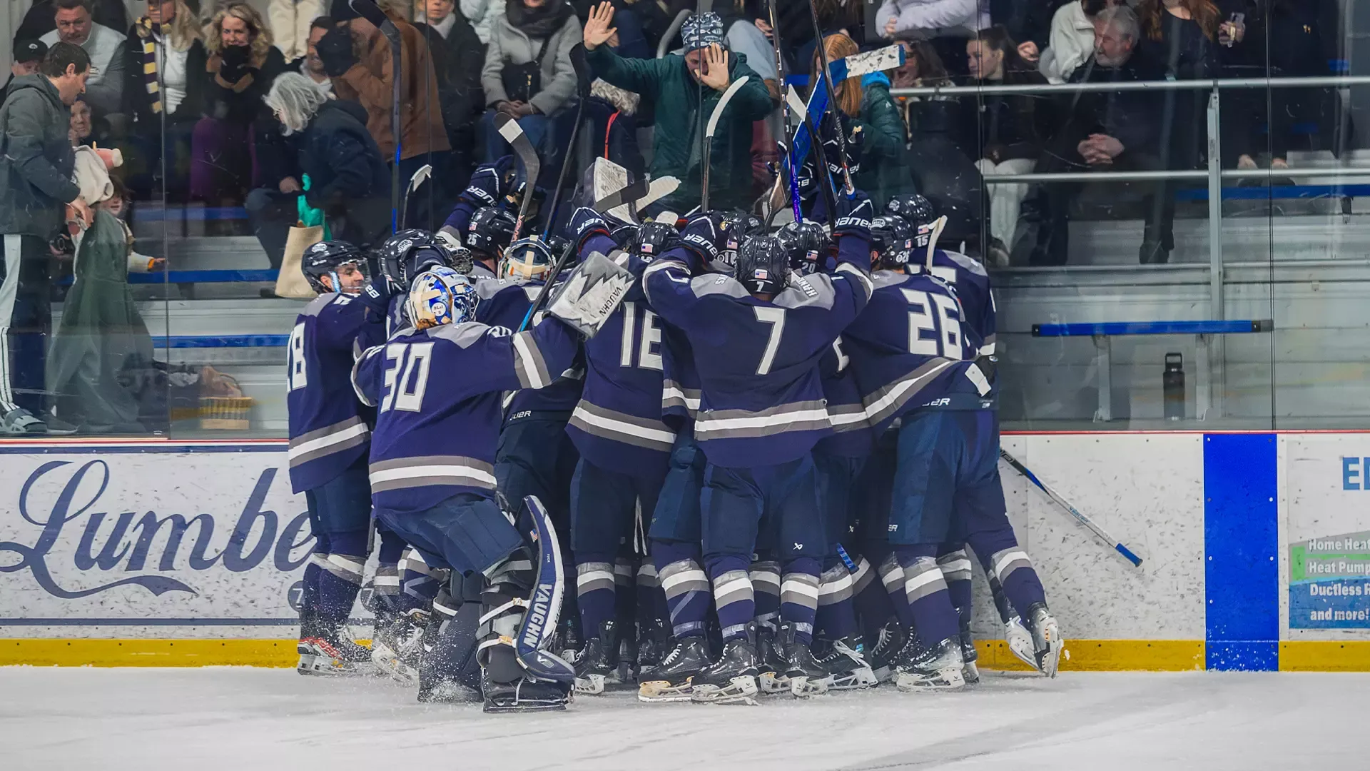 Saint Anselm men's ice hockey team celebrates goal in triple-overtime victory over Saint Michael's in NE10 semifinals - longest game in NE10 ice hockey history
