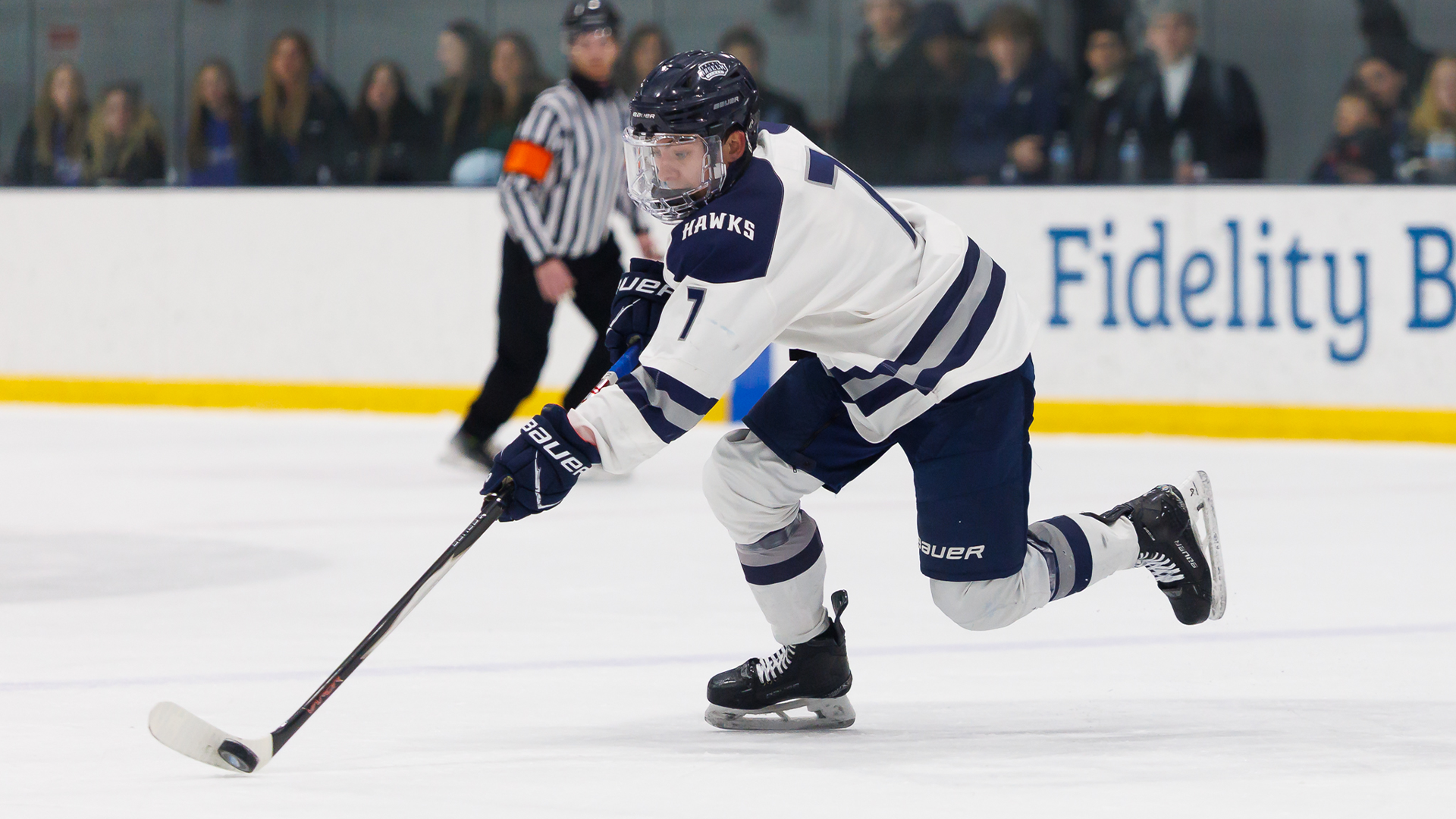 Sebastian Rogles skates with puck
