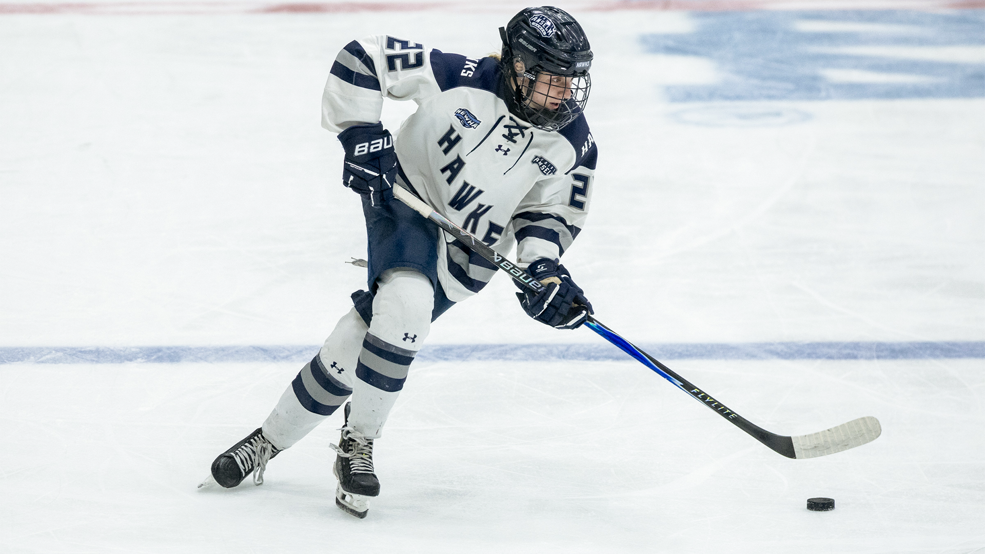 Hailey Tullo skates with puck