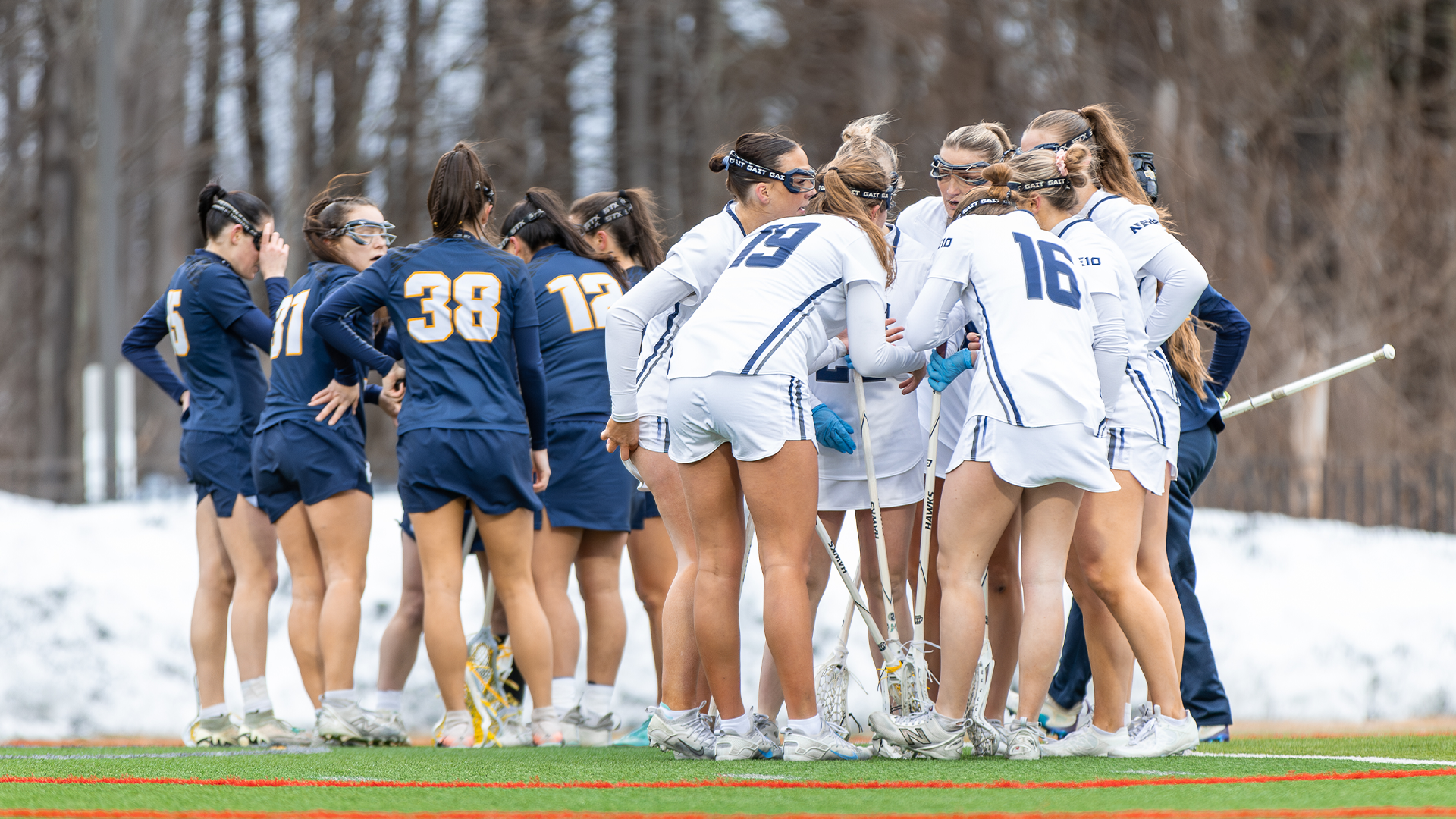 Women's lacrosse teams huddle