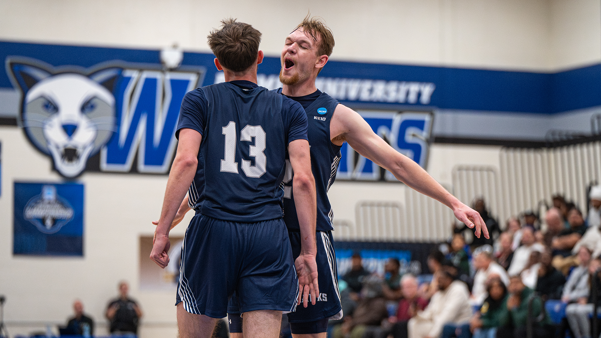 Josh Morissette and Greg Guidinger celebrate after three-point play against Felician