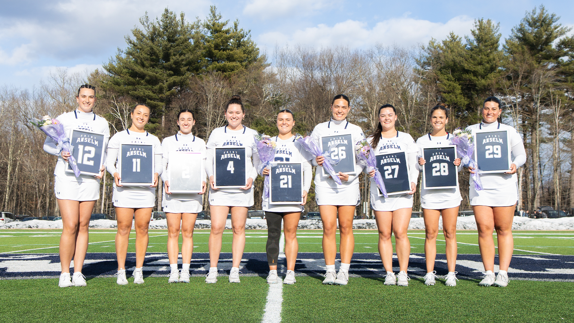 Women's lacrosse players pose for senior day photos