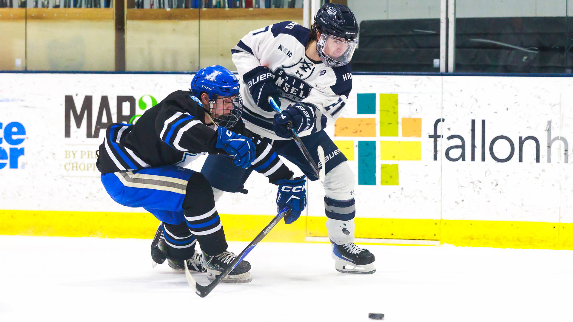 Isac Martins shoots around Assumption player