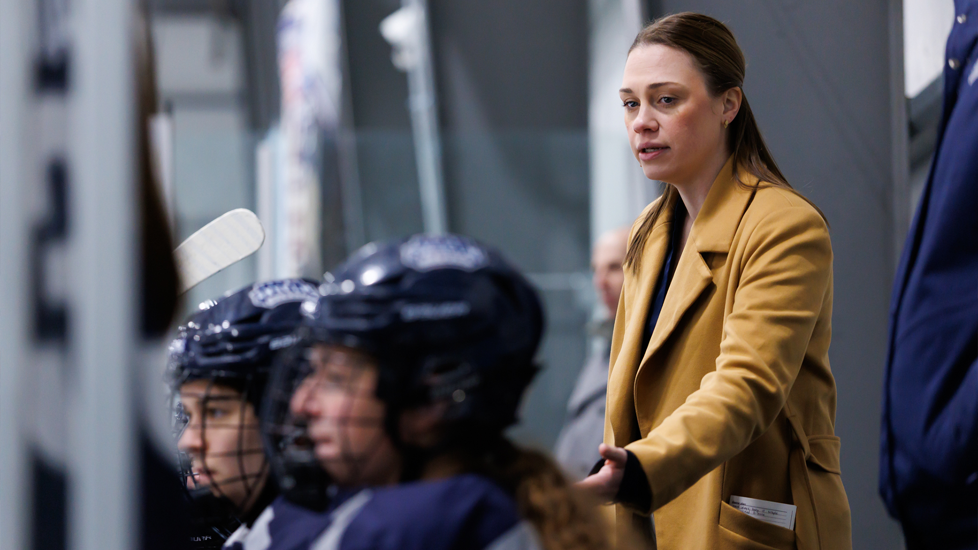 Jessica Salisbury coaches players on bench