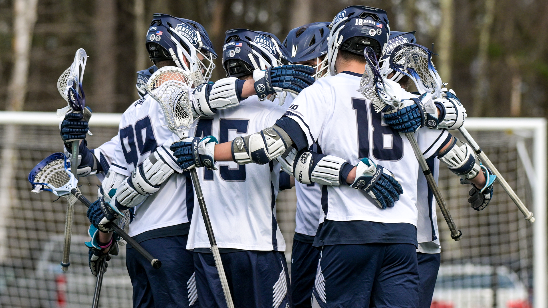 Men's lacrosse players celebrate goal
