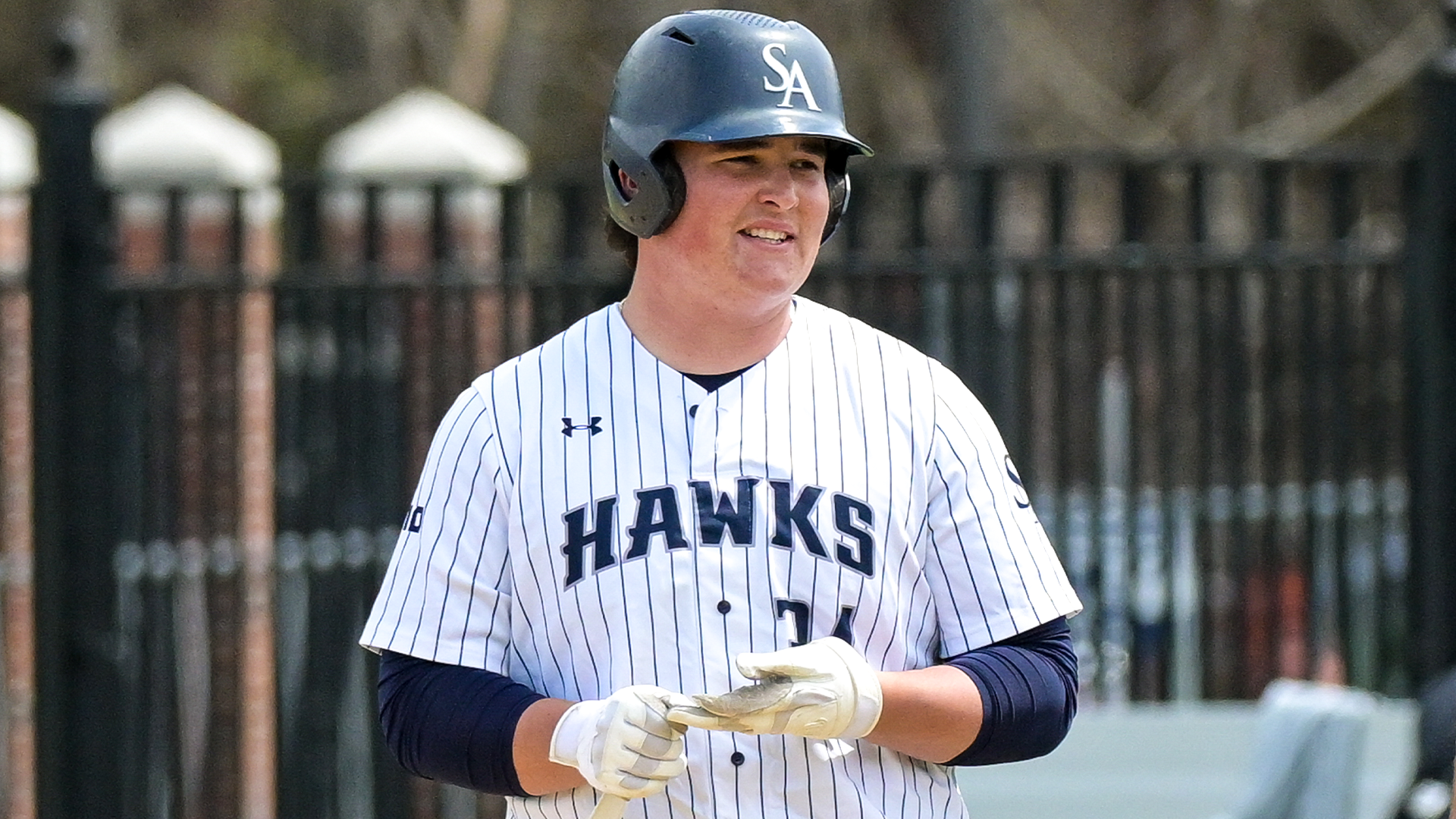 George Slauson removes batting gloves after reaching first base safely