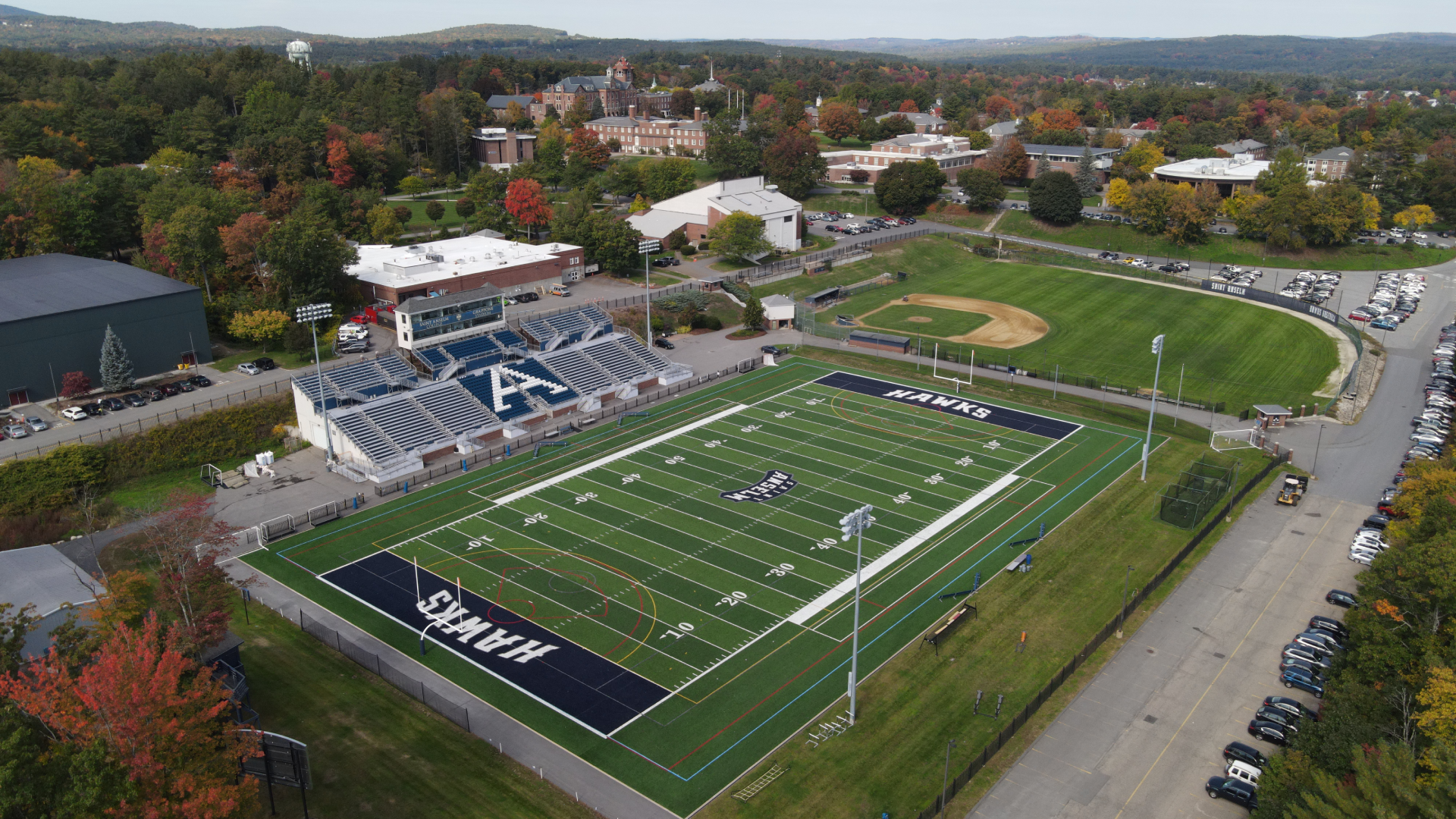 Aerial photo of the Saint Anselm College campus featuring Grappone Stadium in foreground and campus and views in background
