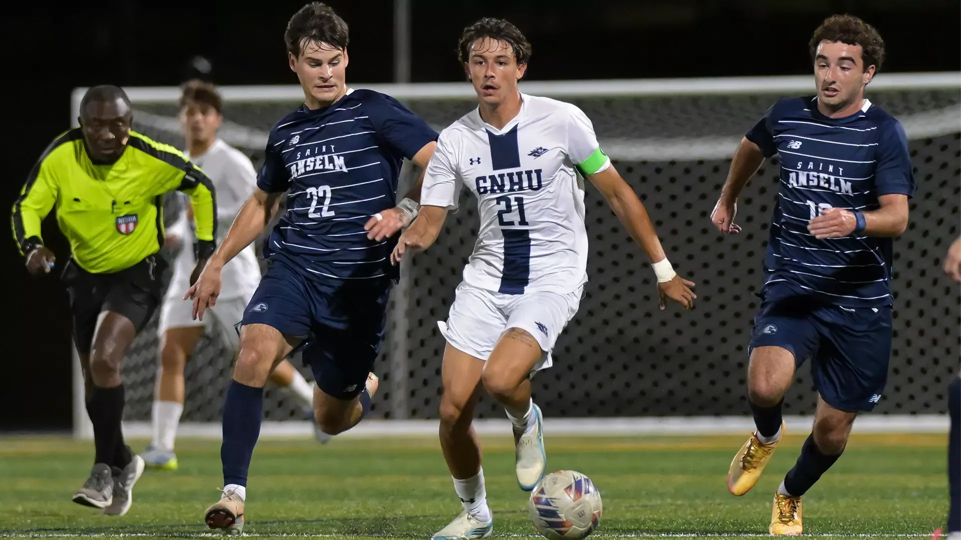 Men's soccer players battle SNHU on the soccer field. 