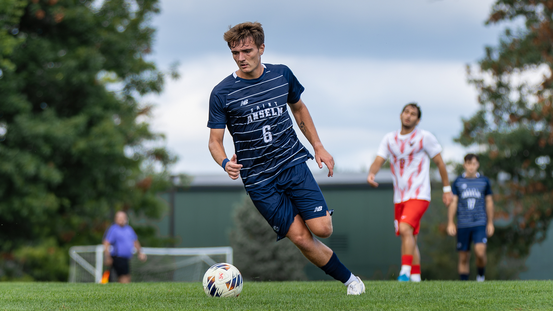 Brian Jones dribbles the ball upfield during a Saint Anselm men's soccer match at Melucci Field.