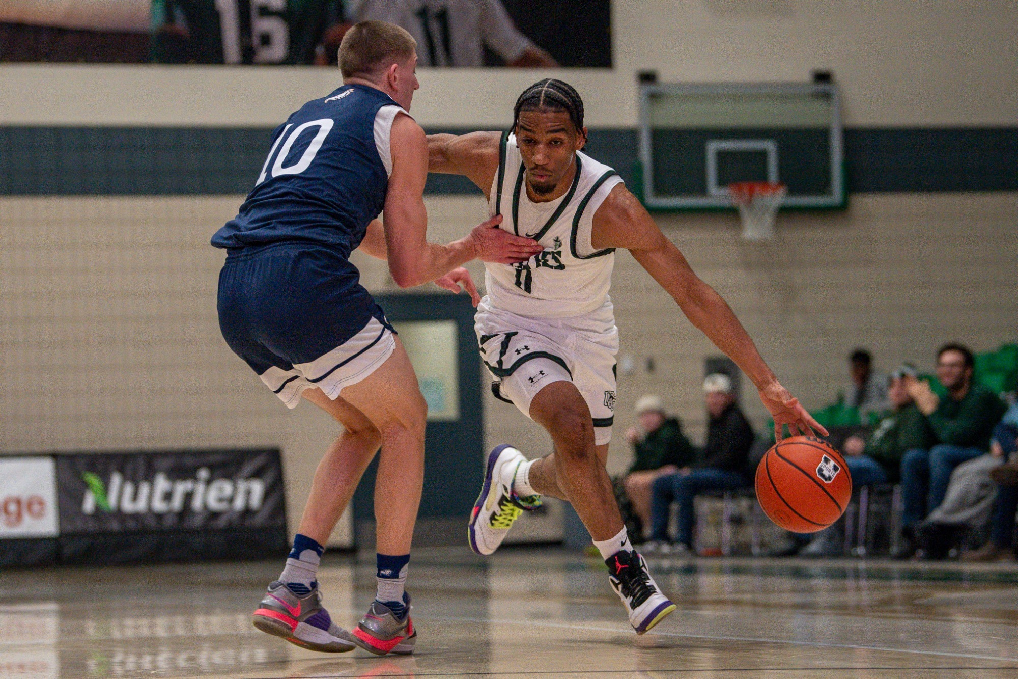 Mohamed Mahadhi Drives to the Basket Against the UBC Defender
