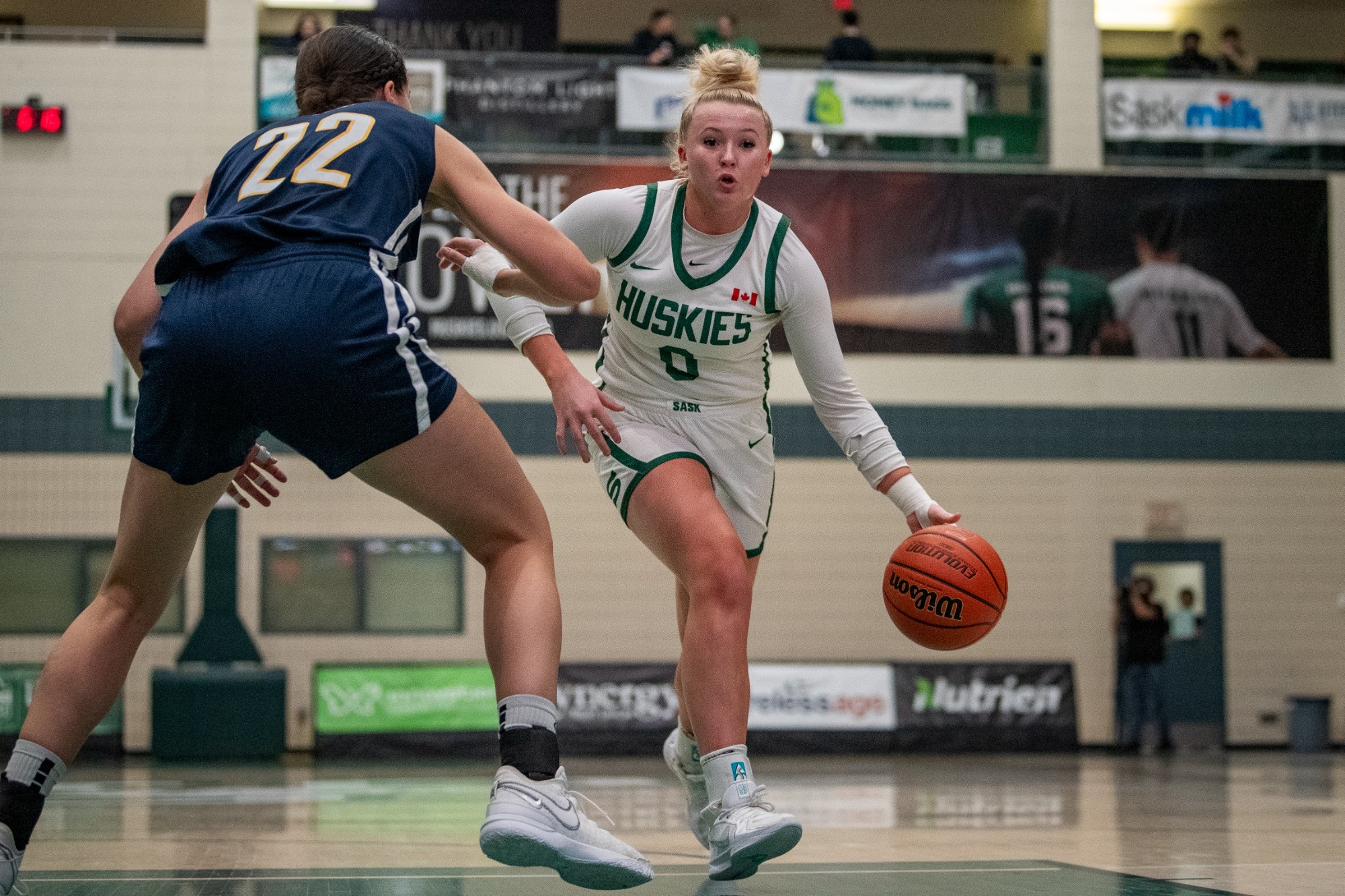 Logan Reider Drives to the Basket Against Thunderbirds Defender