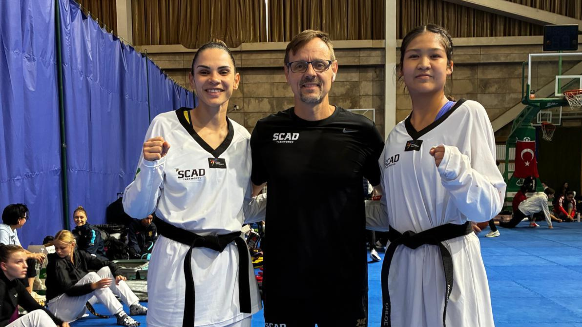 Chloe Chau and Caroline Santos pose with Head Coach Lucas Rodrigues at the Women's World Championship.