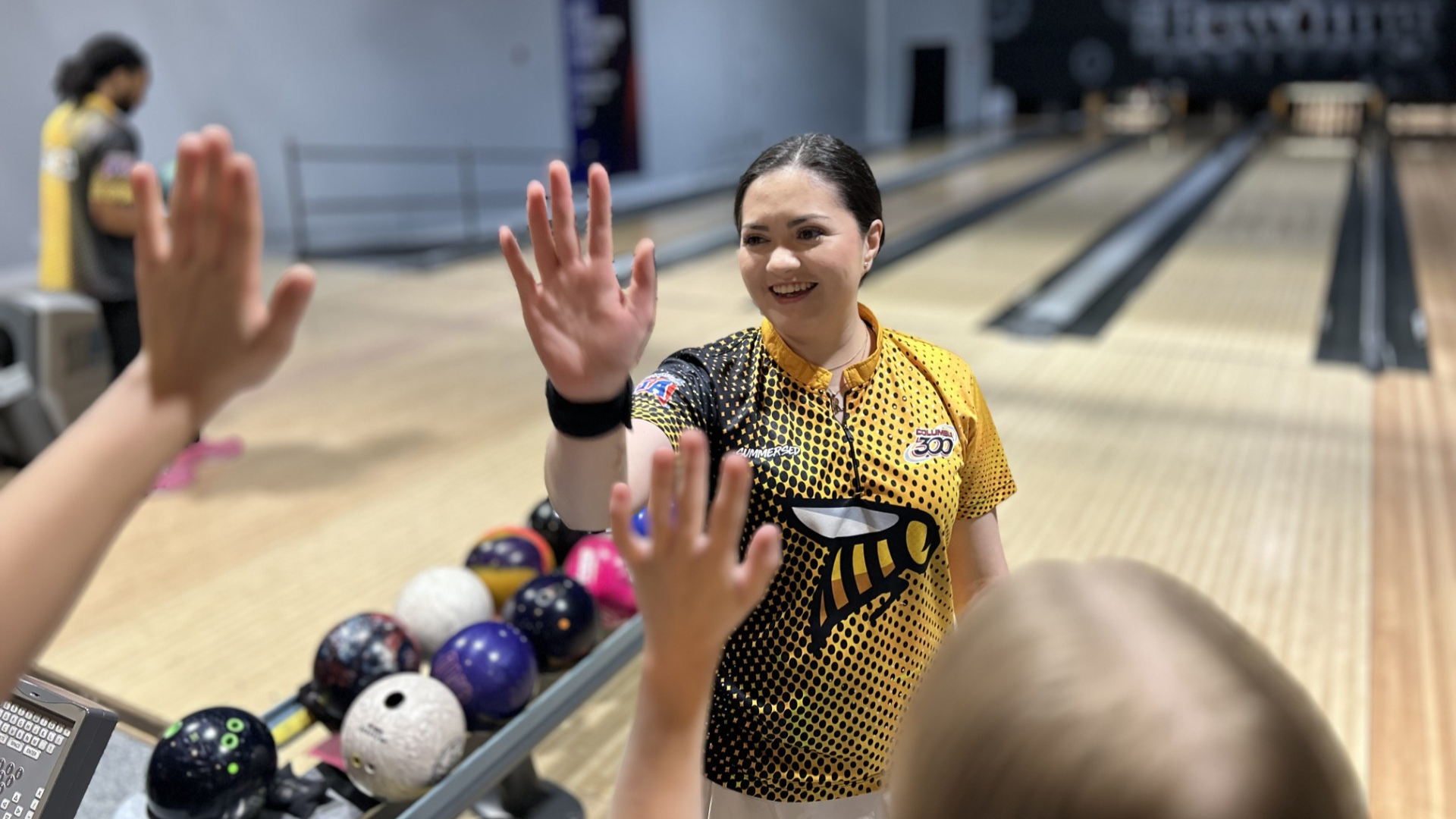 Camila Canelos high-fives at the Midwest Collegiate 