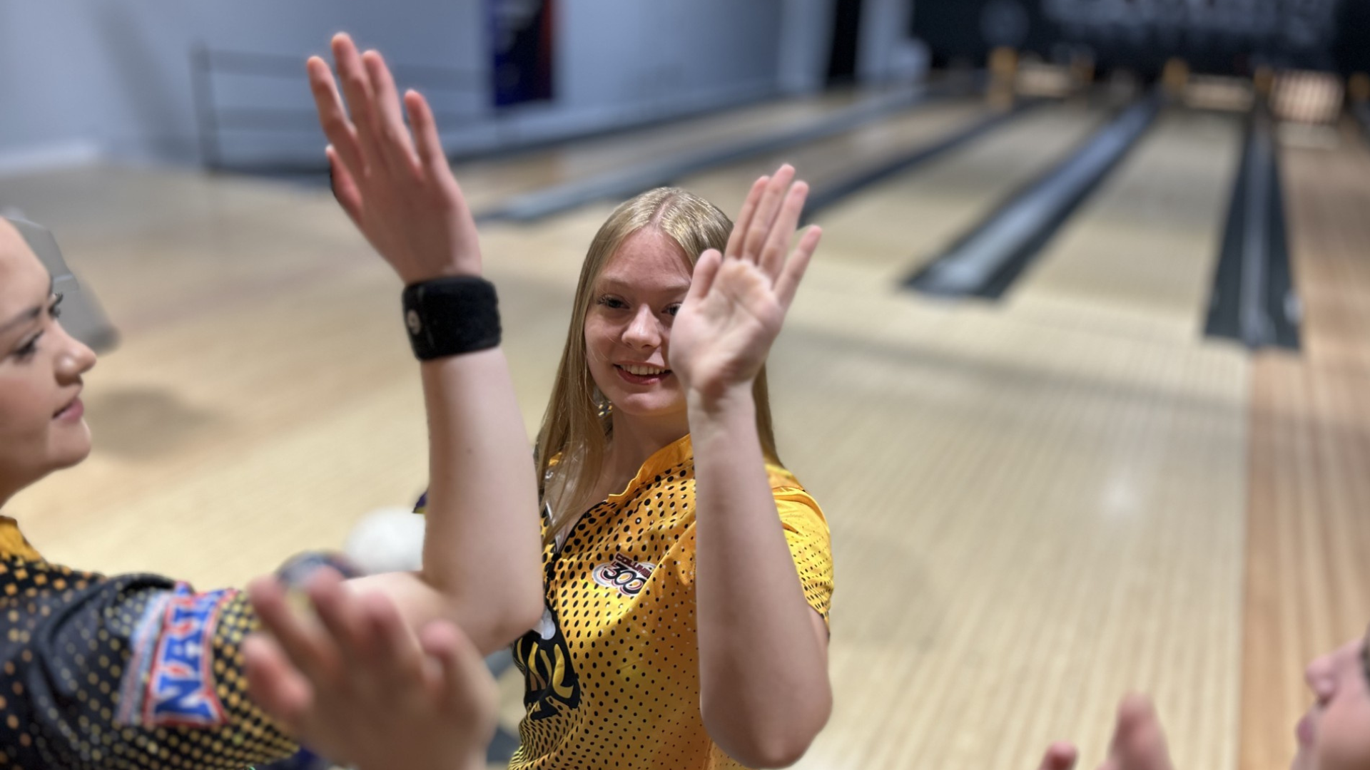 Chloe Manifold high fives other SCAD athletes at the Columbia 300 Hoosier Classic.