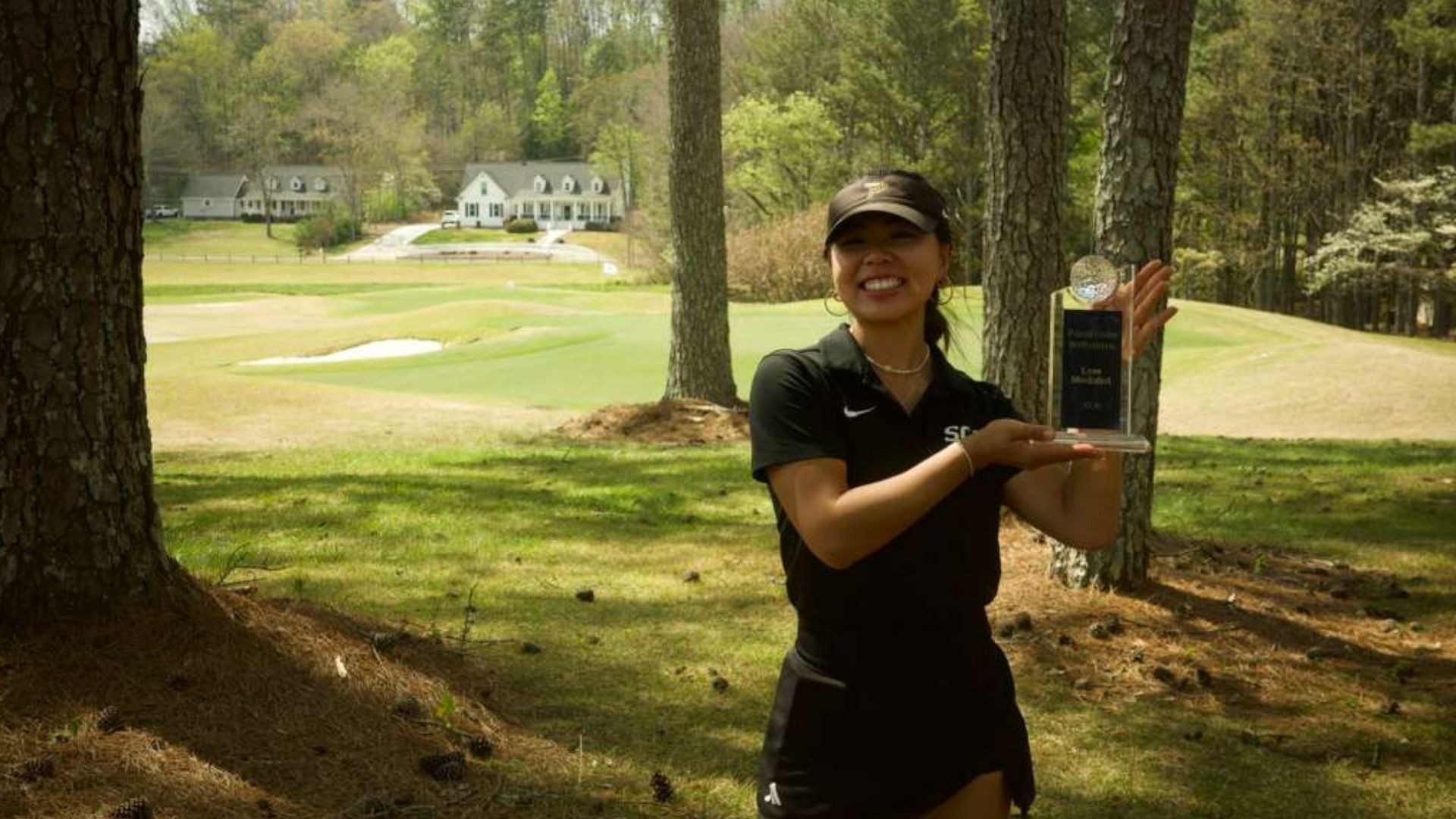 Junior Holly Lau poses with Roadrunner trophy
