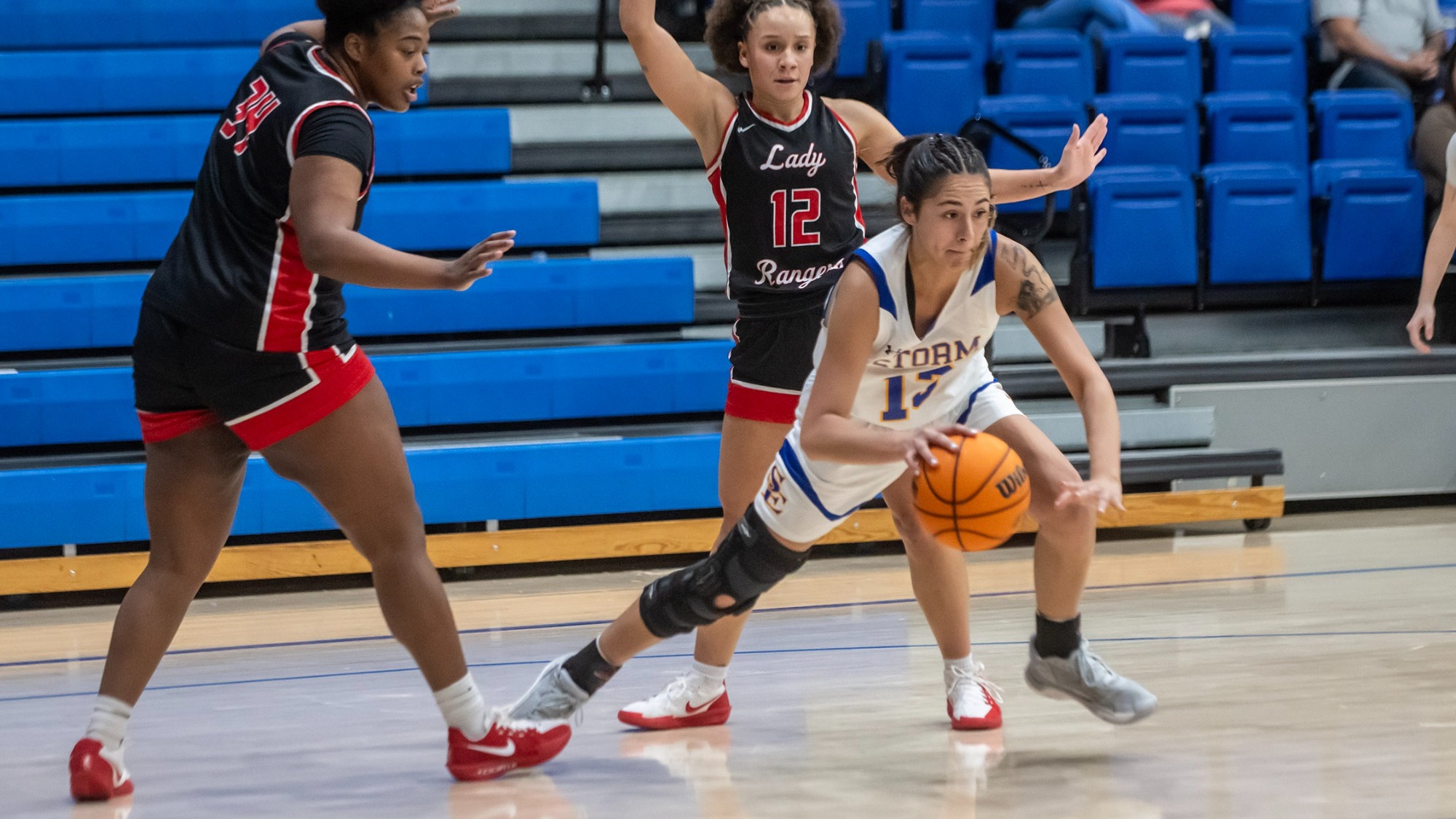Akiera Hawk dribbles away from two defenders versus Northwester Oklahoma State
