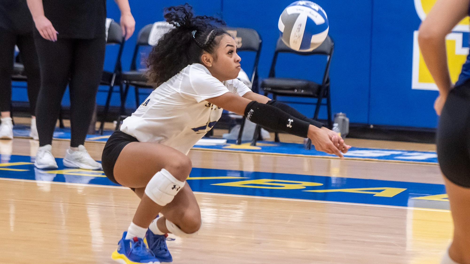 Patience Lewis digs a ball versus Arkansas Tech
