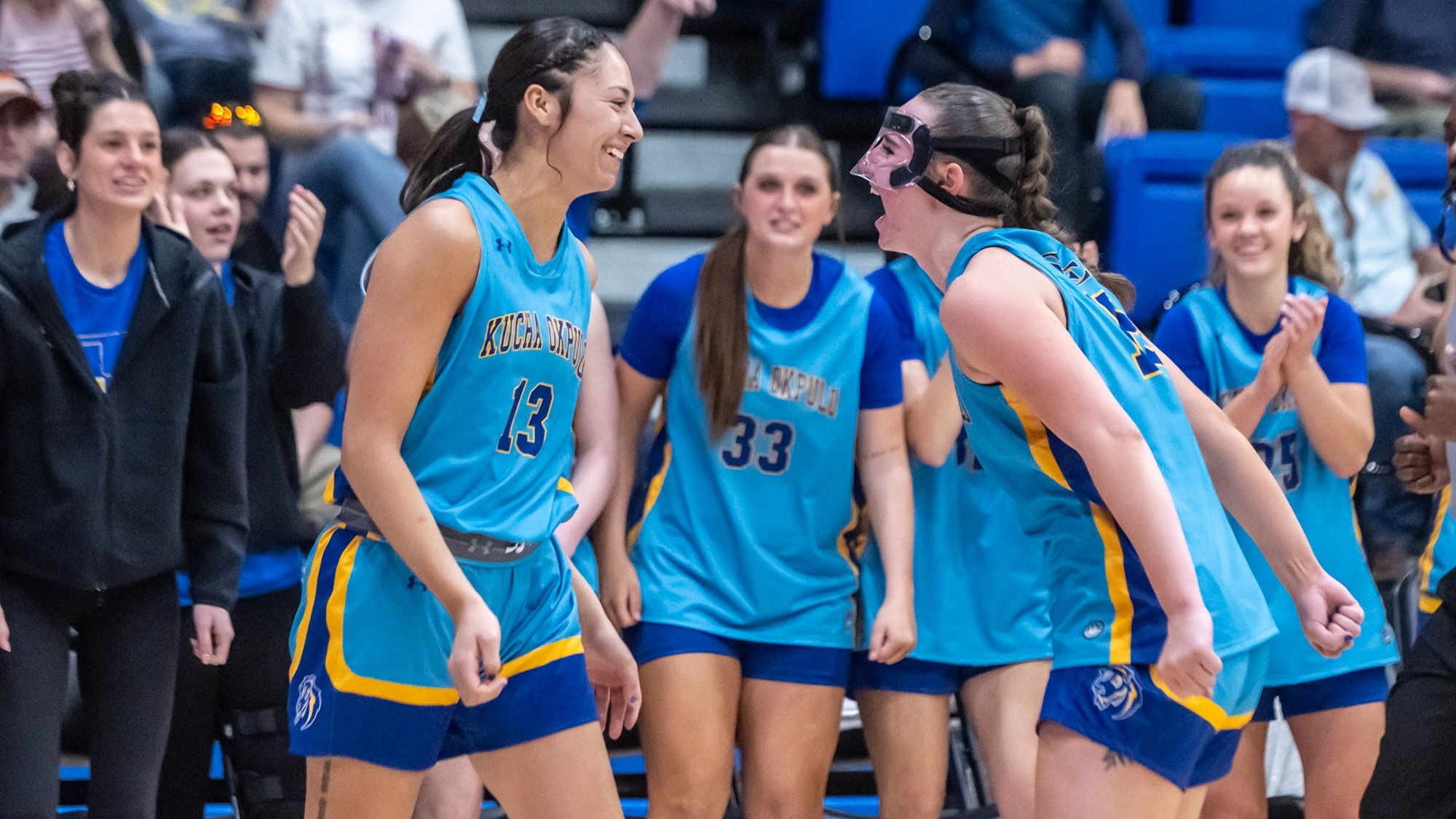 Akiera Hawk (13) and Tori Kilburn (15) celebrate during Southeastern's game versus Southern Nazarene