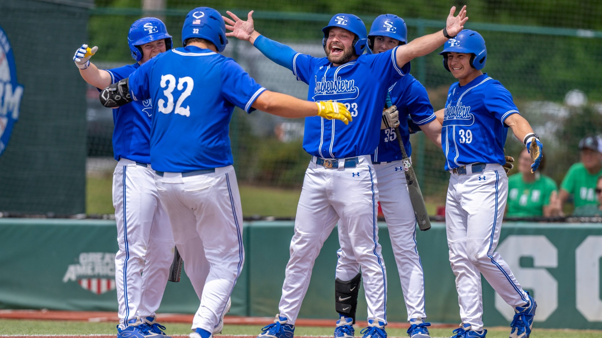 JJ Bush, Isaac Villa, and Carter Olson celebrate Olson's grand slam in the game three win over UAM