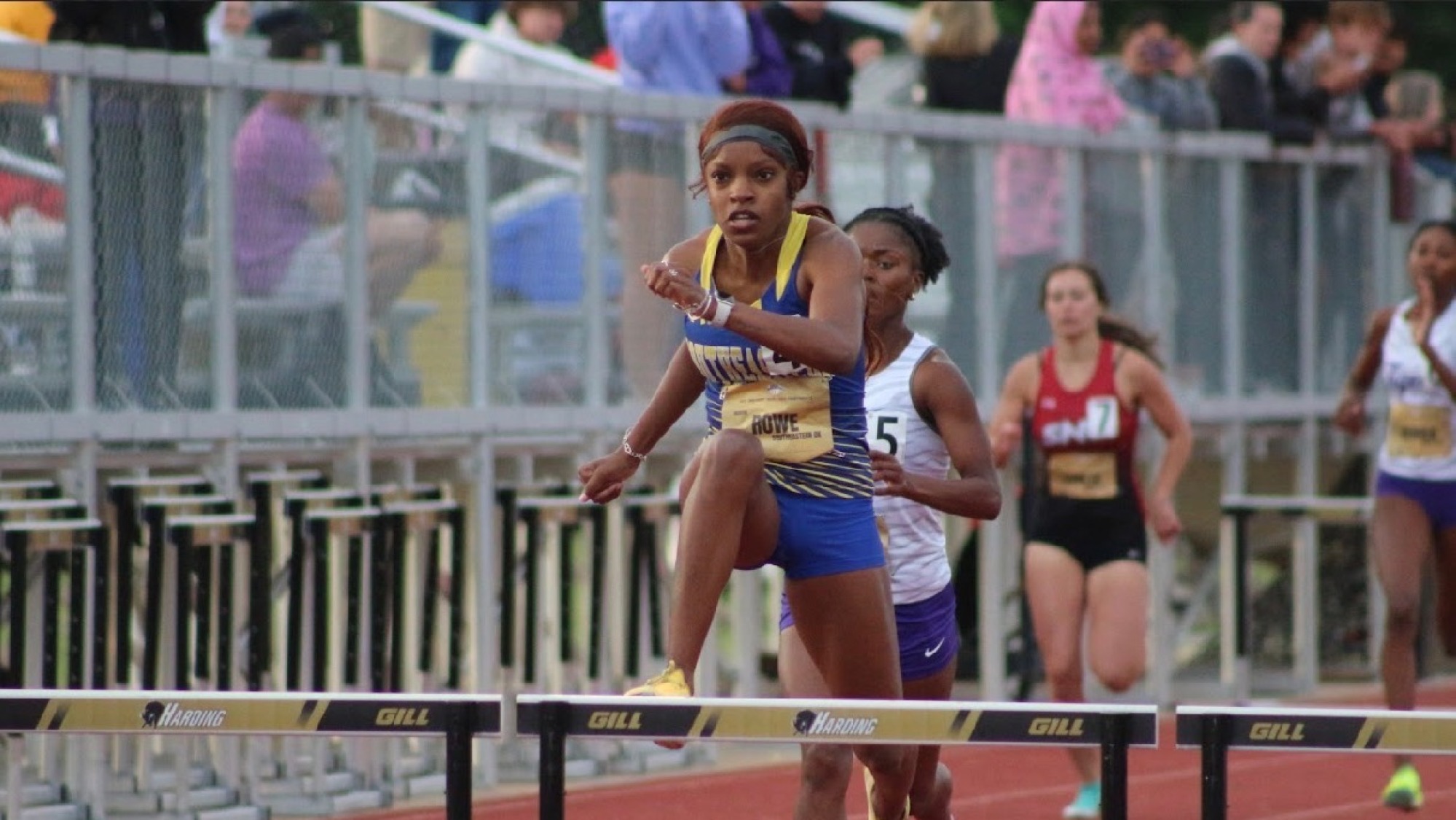 Madison Rowe leaps a hurdle at the GAC Championship meet