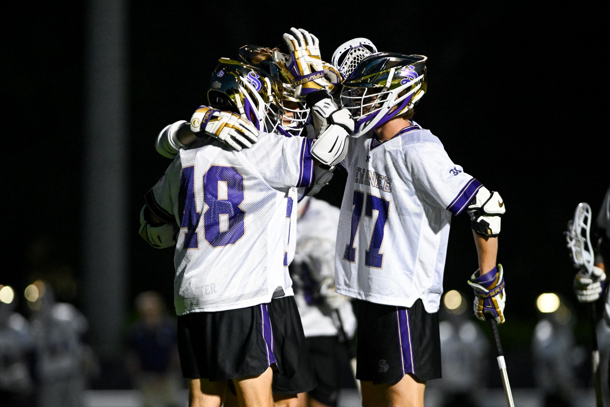 men's lax celebrating goal