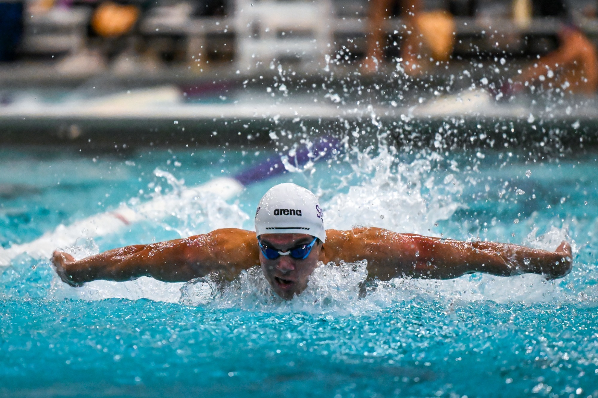 Men's swimmer attempting a butterfly stroke for Sewanee