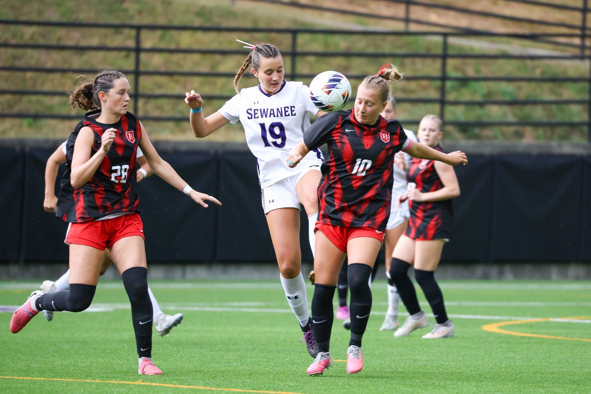 Pope Scurlock between two Rhodes defenders