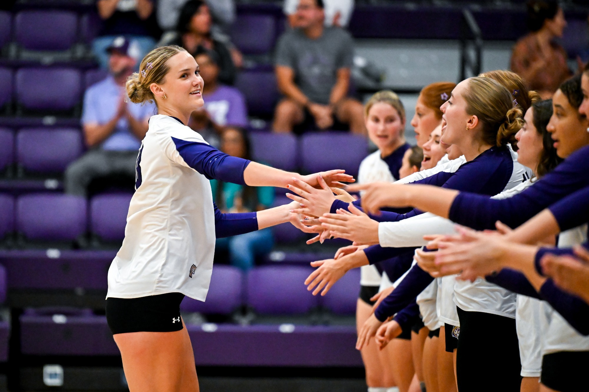 Savannah Gann high-fives her teammates during lineup announcement