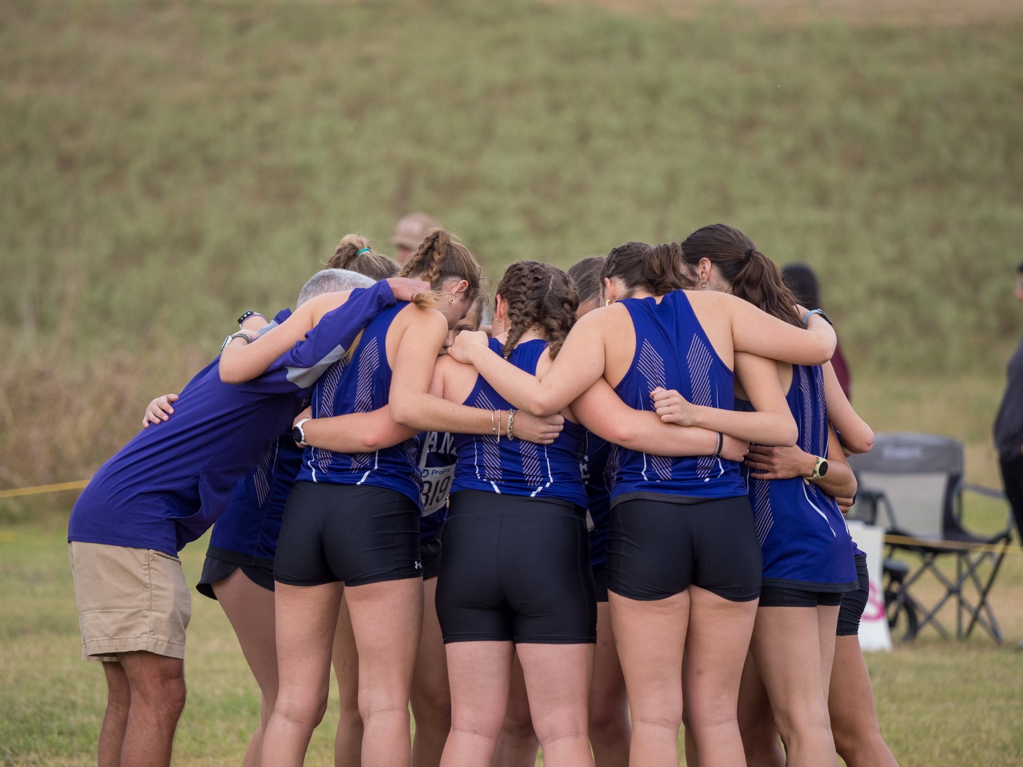 women's cross country team huddle