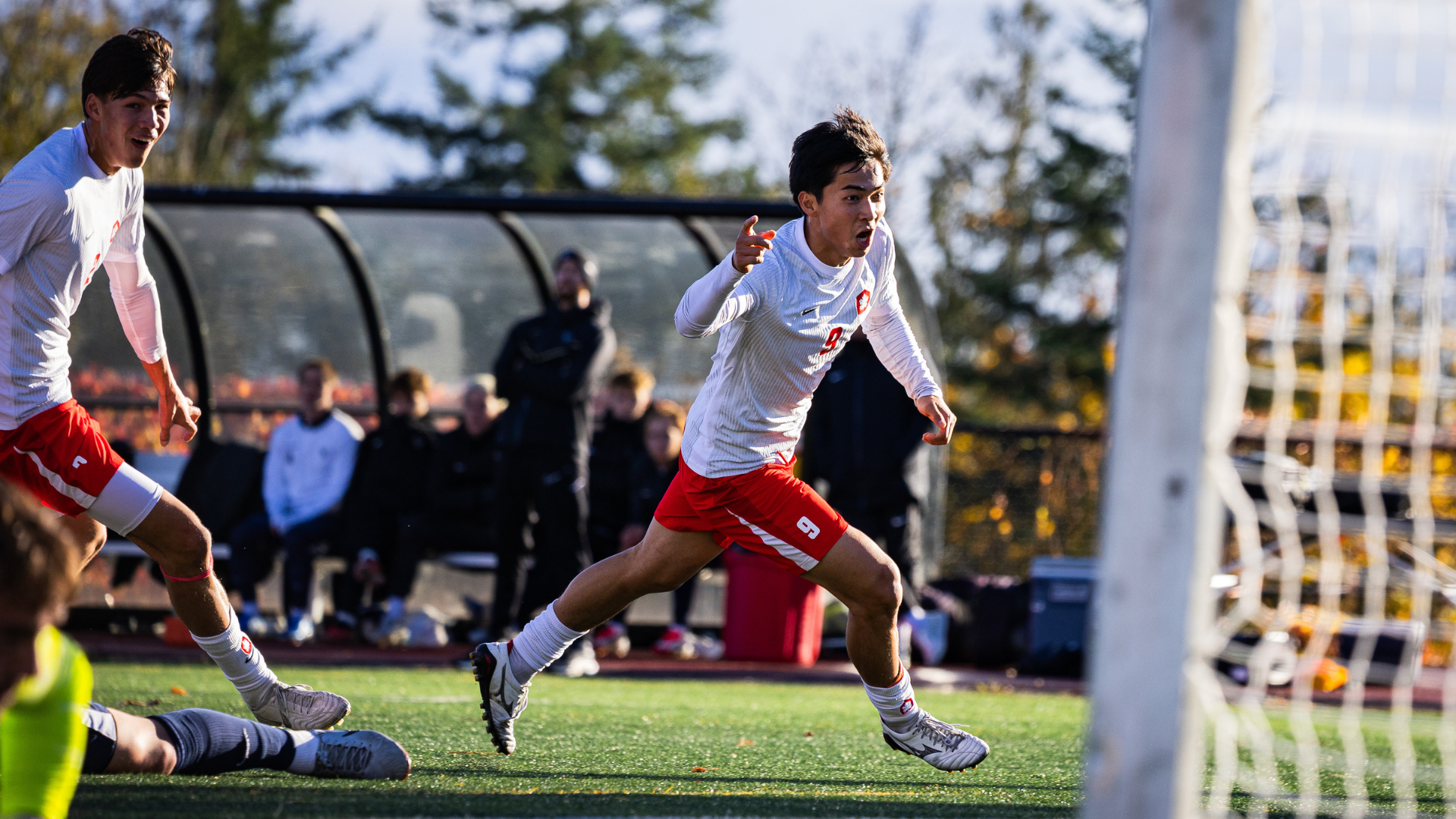 SFU Men's Soccer player Koji Poon celebrates after scoring a goal.