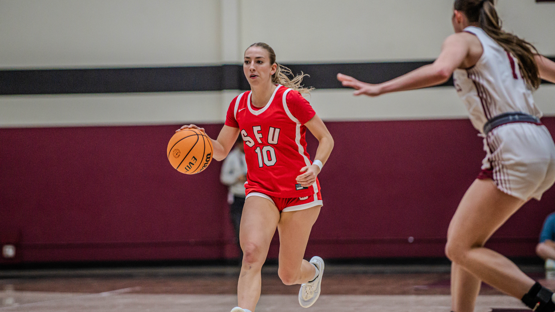 SFU Women's Basketball's Hailey De Walle dribbles the ball up the court.