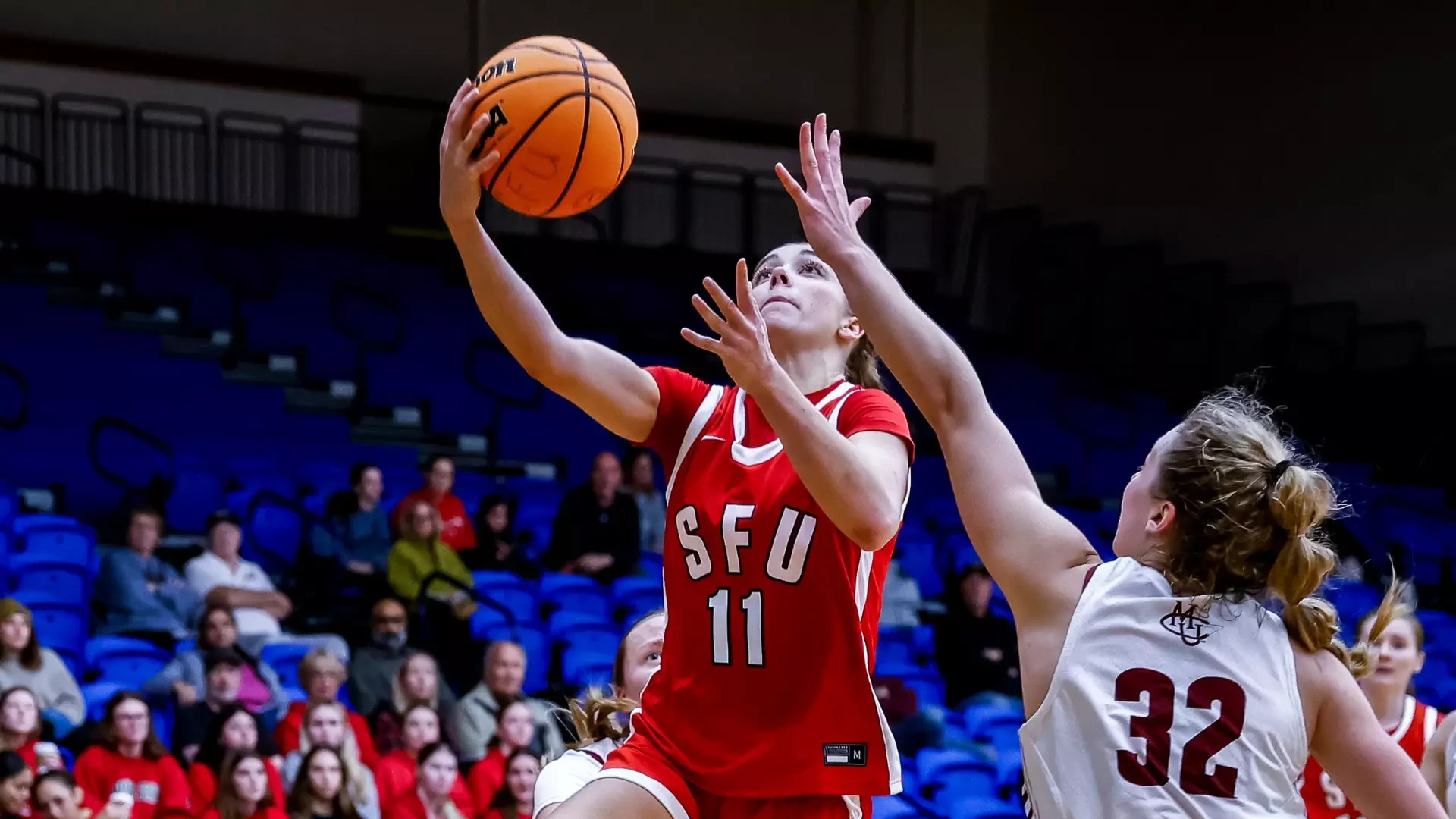 SFU Women's Basketball player, Sophie Bergeron, laying up to the net.
