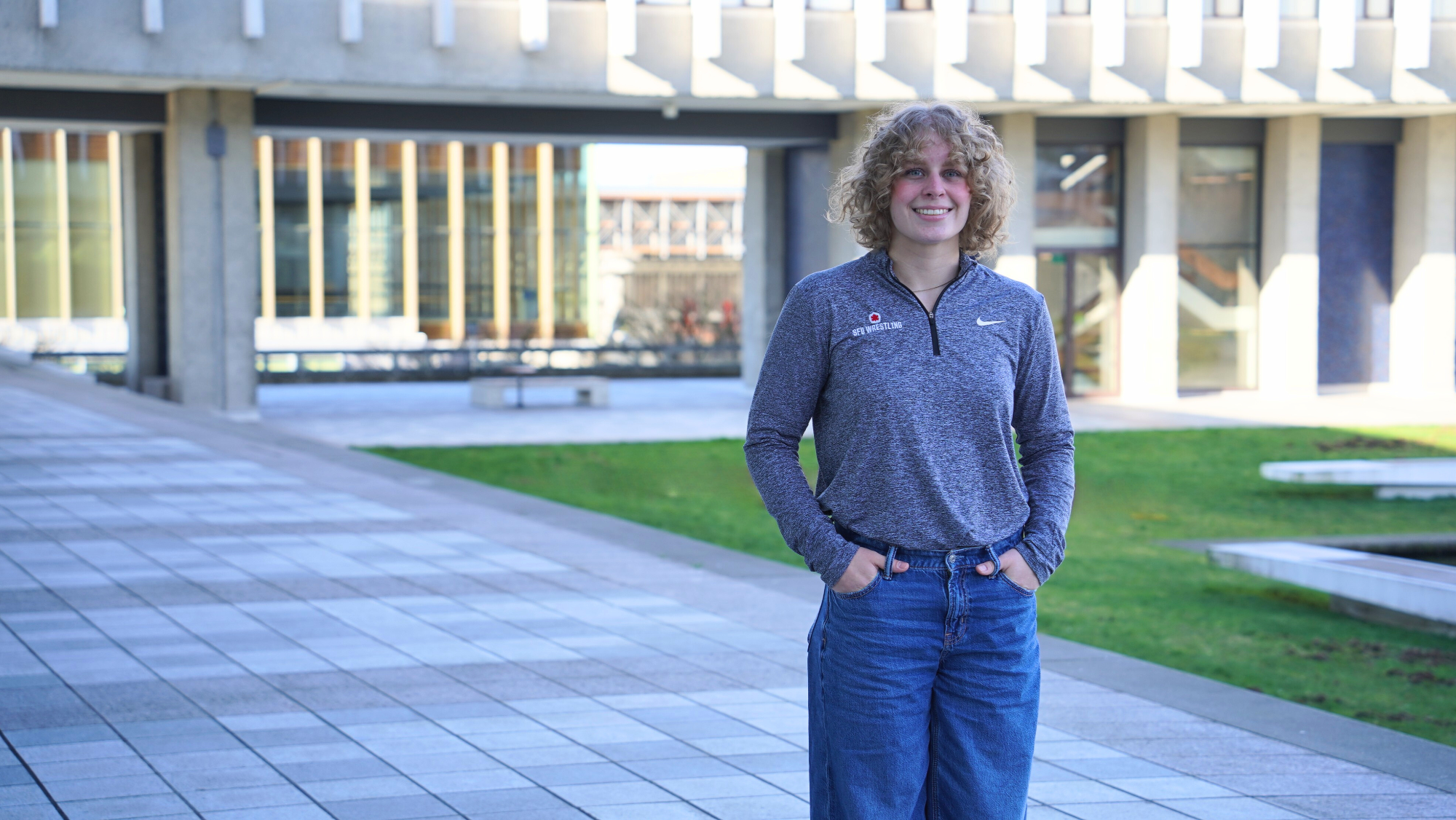 Liv Wieber smiles while standing outside at SFU Burnaby's campus.